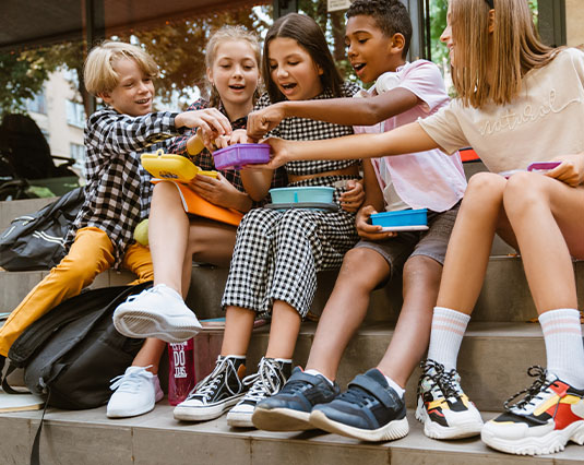 Preview image of group of children sitting outside enjoying after-school snacks