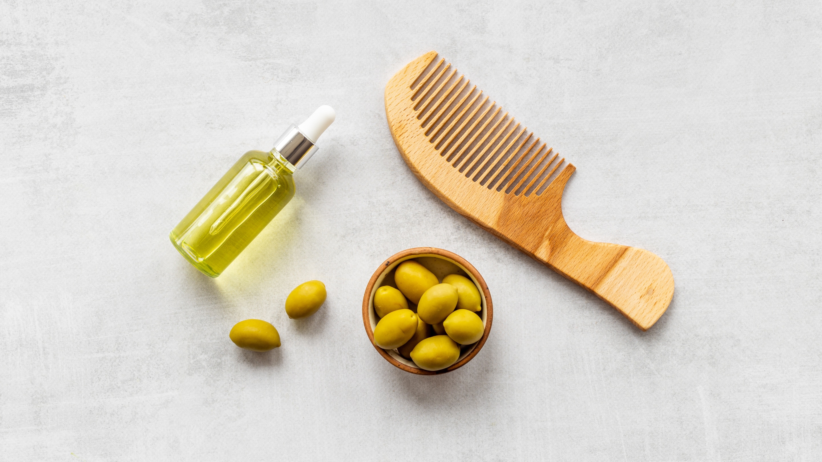 Olive oil bottle with comb showing hair care routine