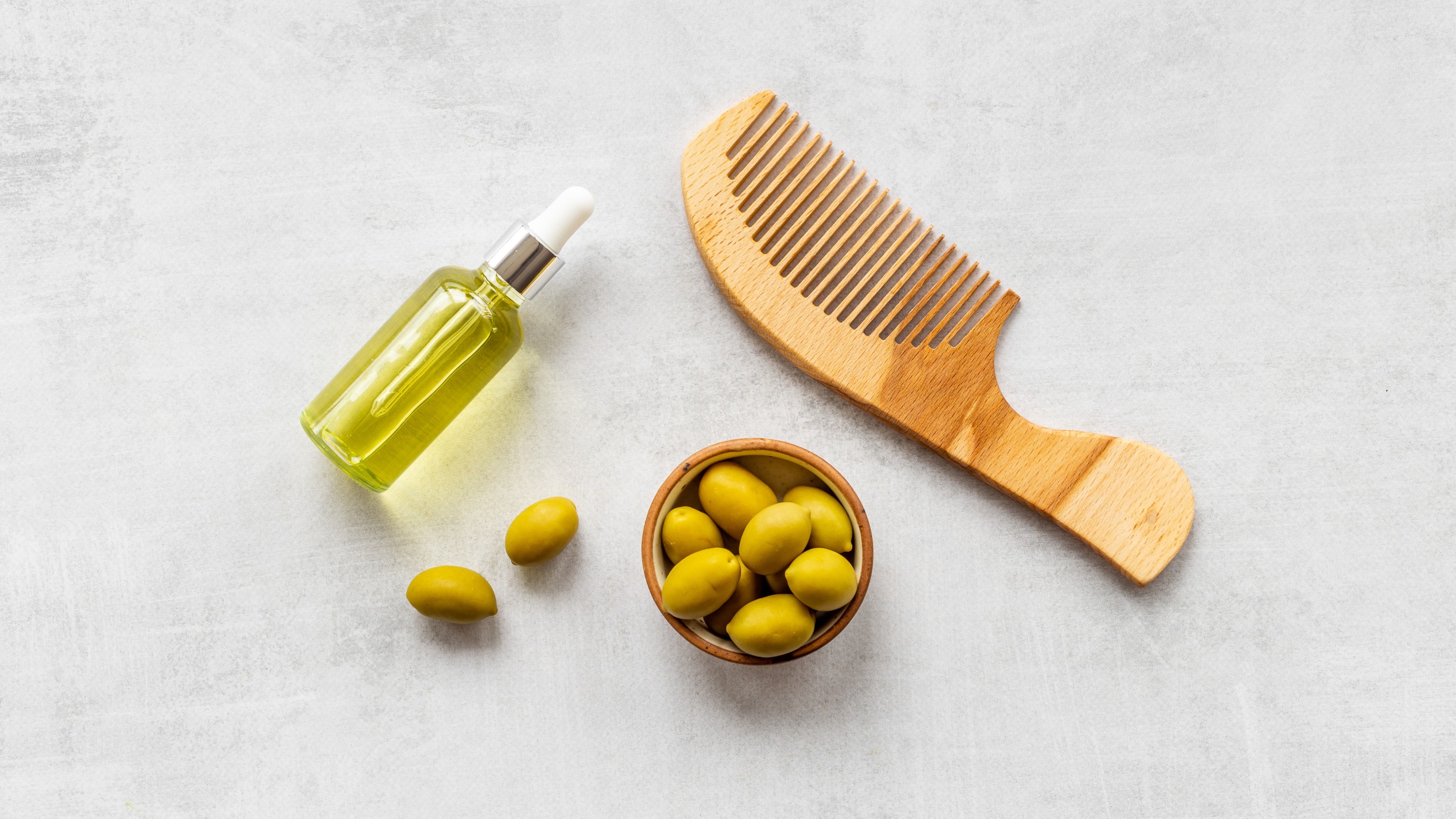 Olive oil bottle with comb showing hair care routine