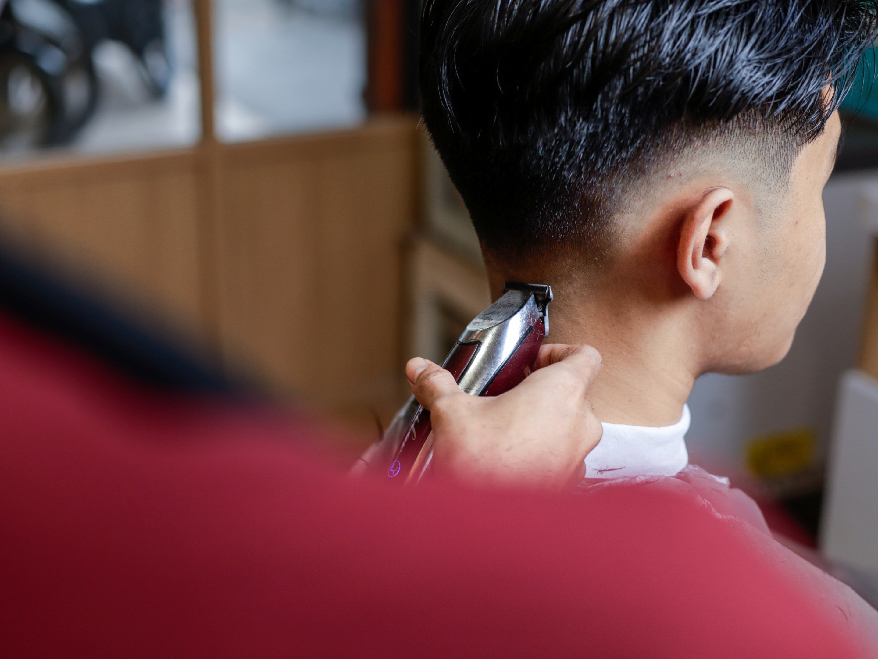 Man getting clean fade hairstyle from barber.