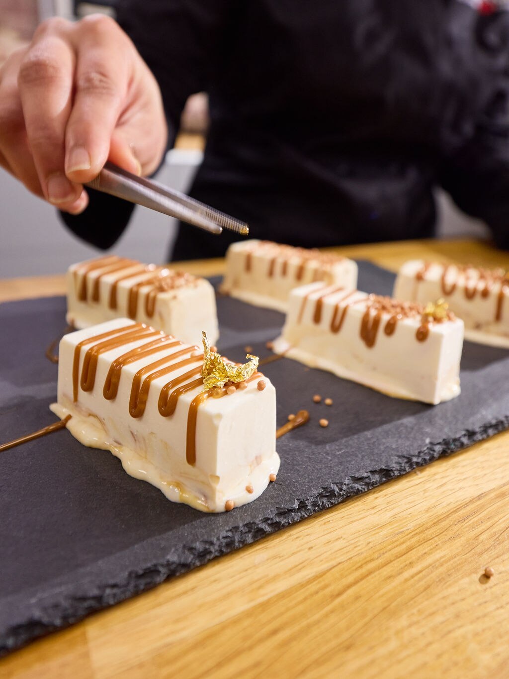 An ice cream with decorative sauce and ingredients on top