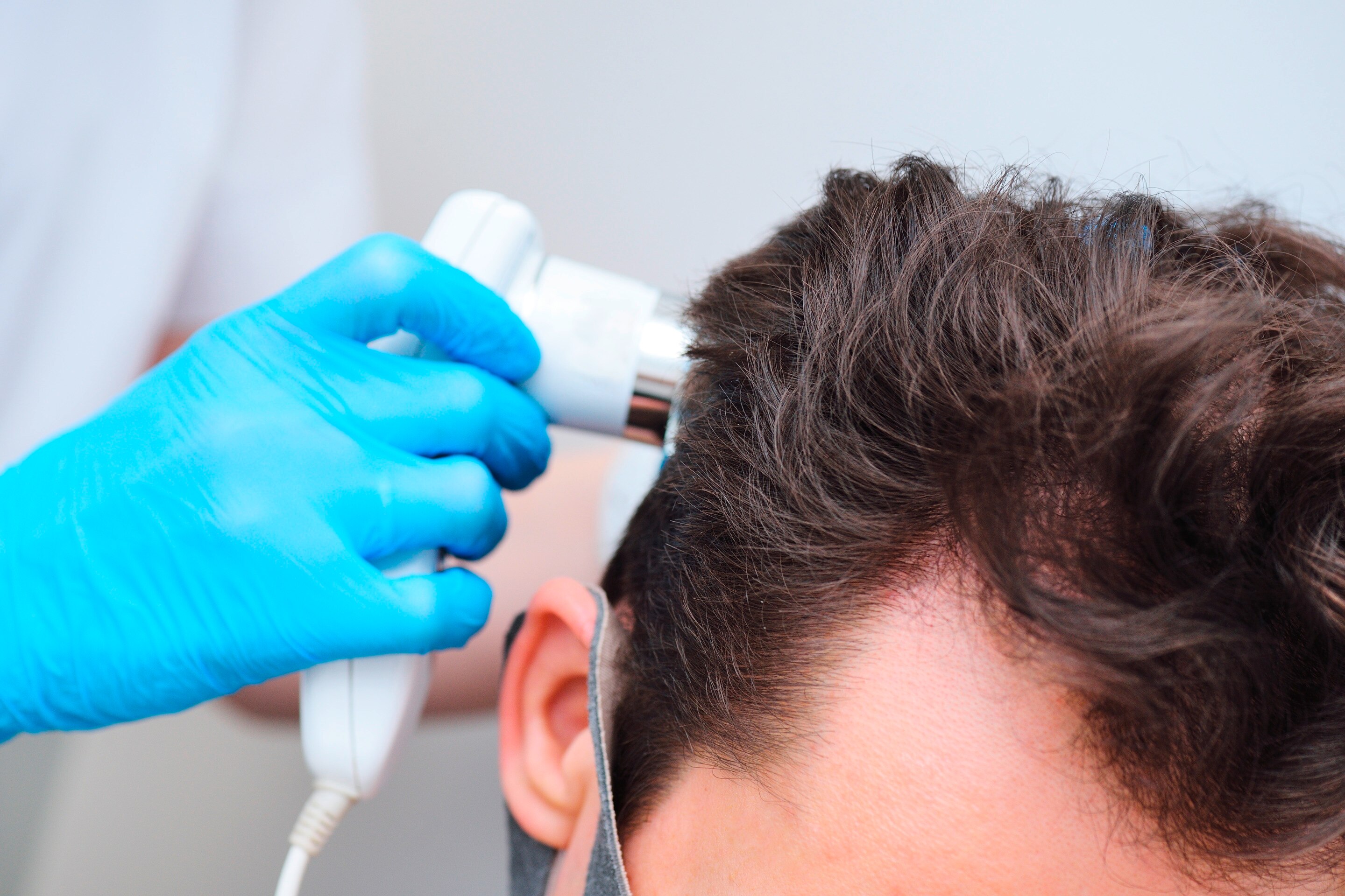 Man gets hair and scalp check.