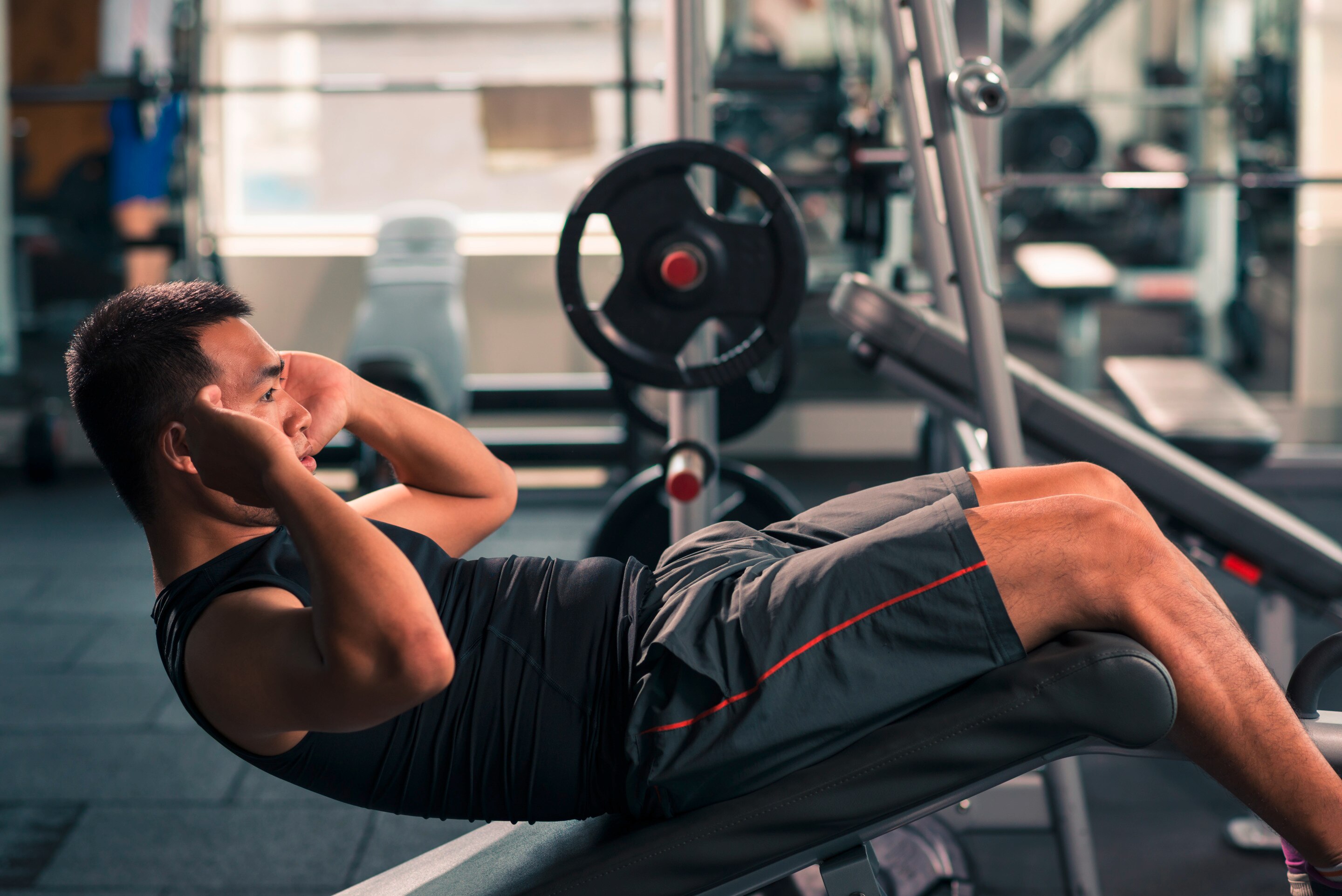 Man doing crunches at gym.