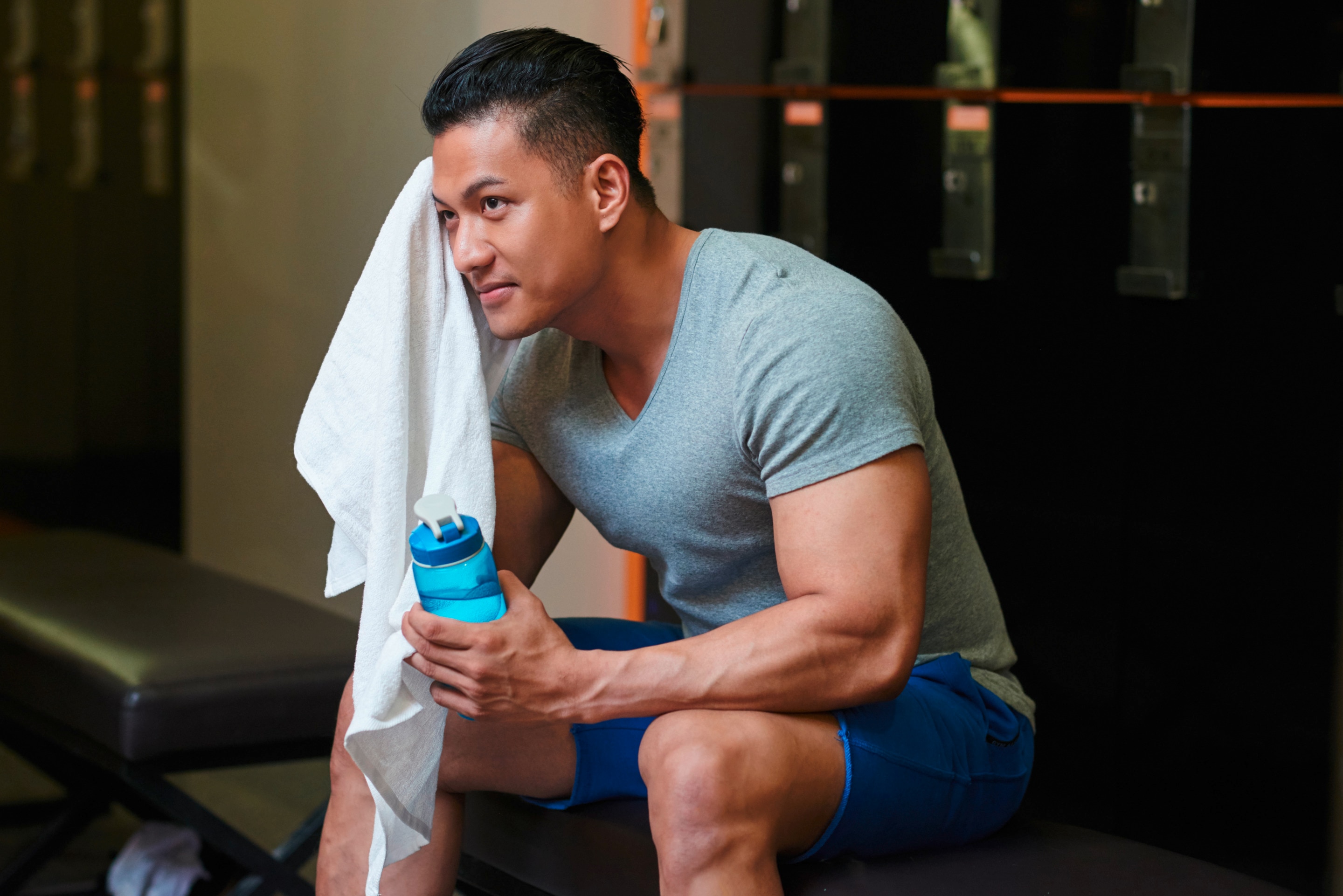 Asian man wiping sweat.