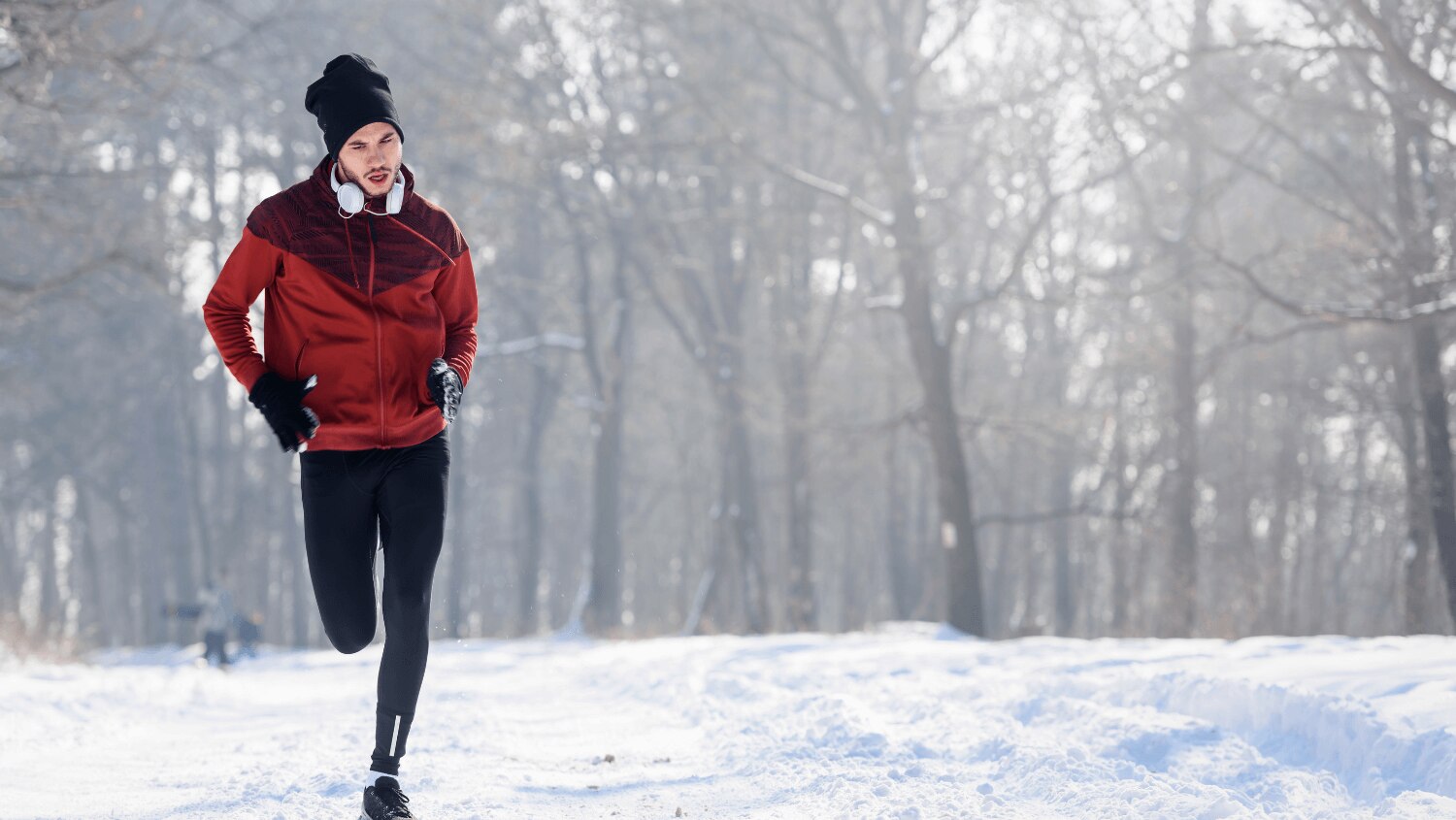 Young man working out outside in the cold Winter snow