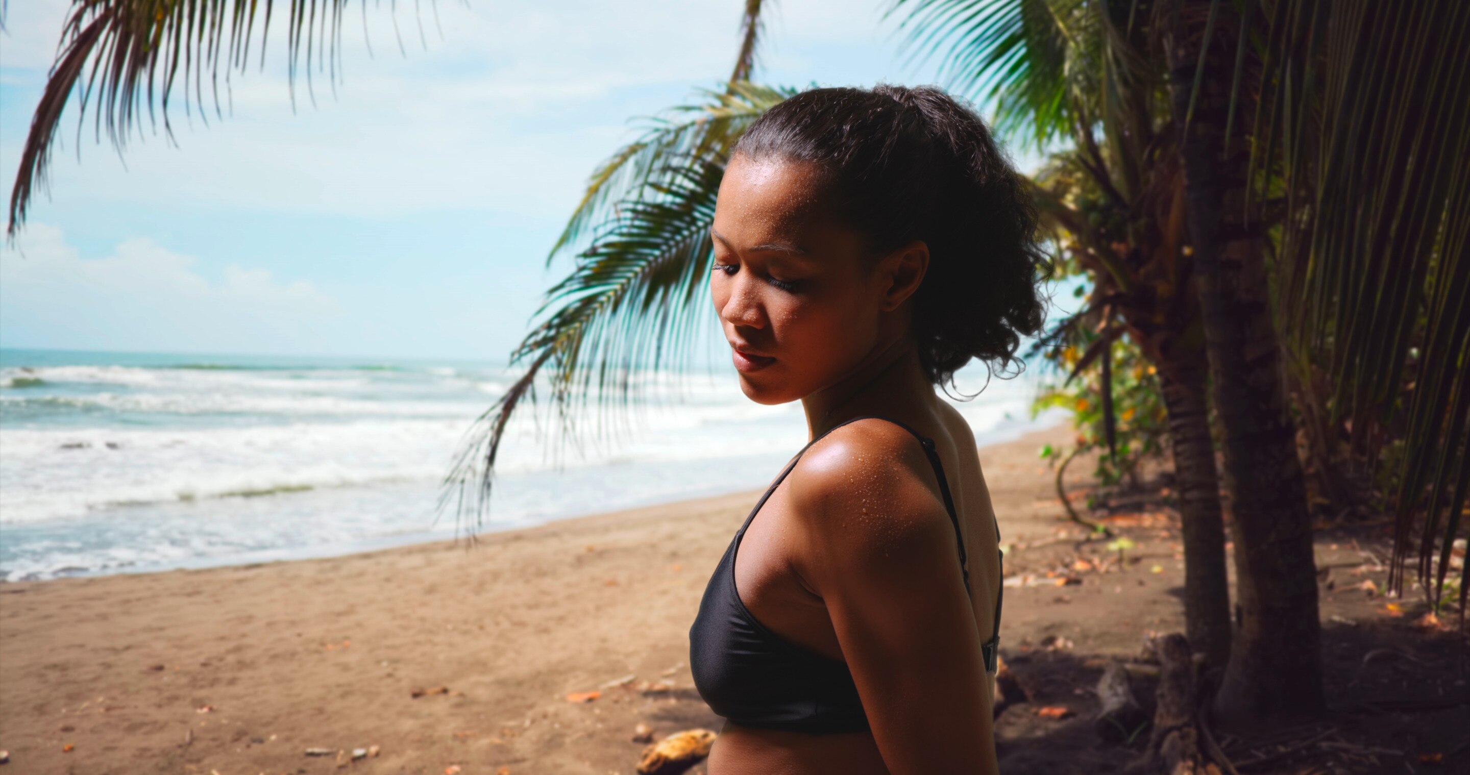 Asian woman without body acne wearing bikini on the beach.