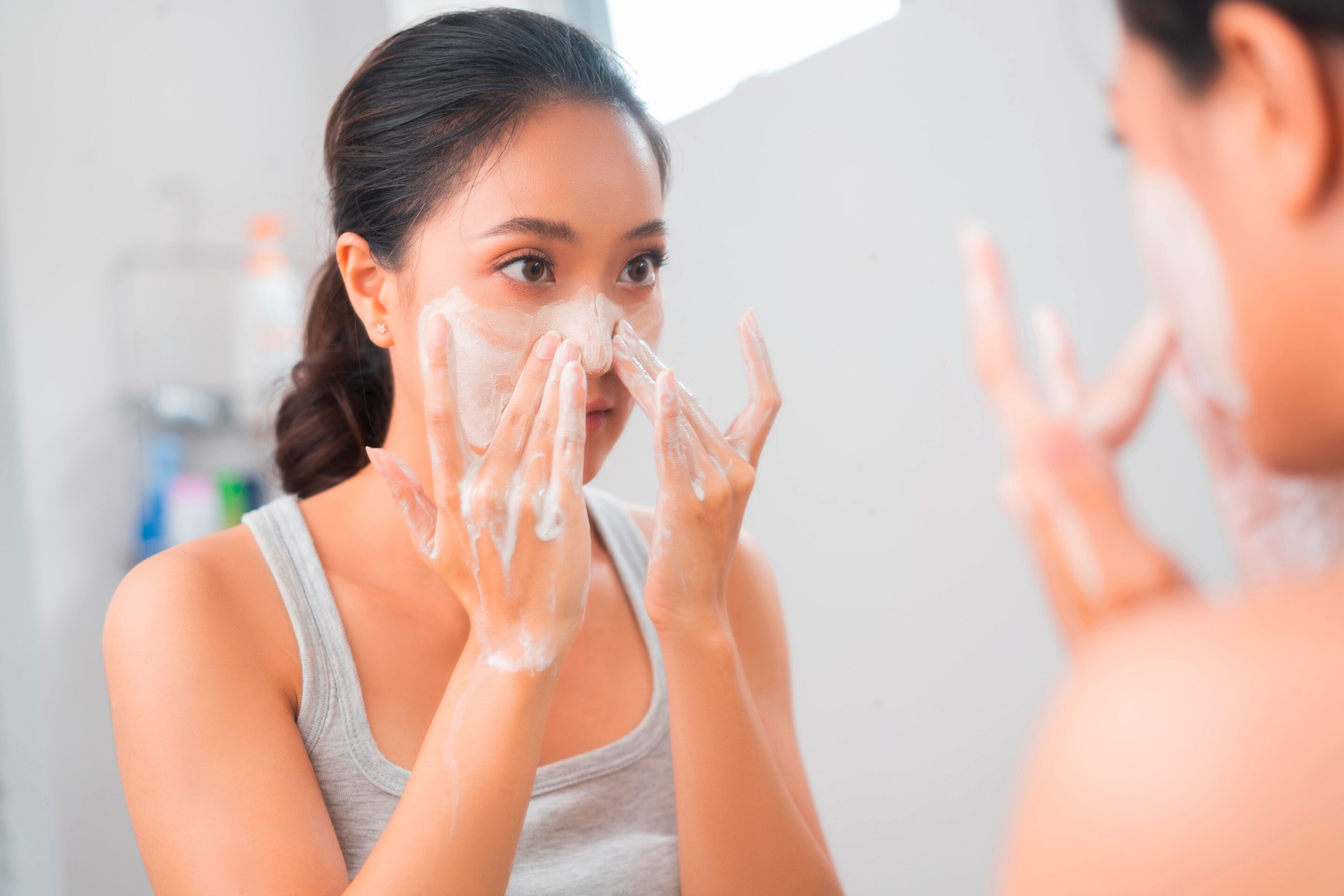 A woman washes her face.