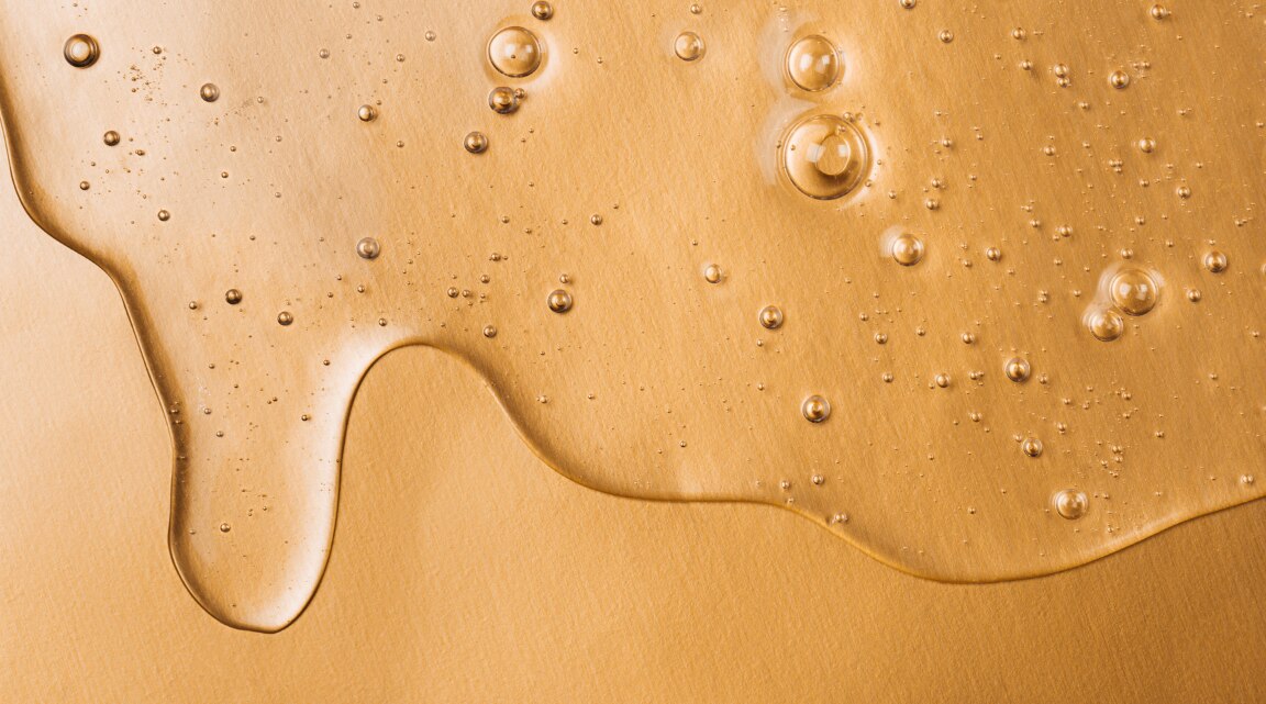 Woman applying tranexamic acid serum to improve skin tone