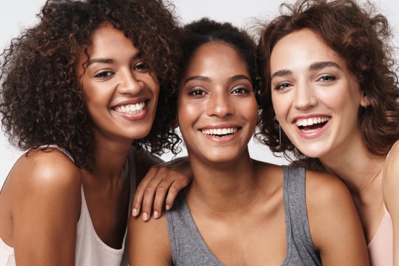 Three girls smiling with glowing face