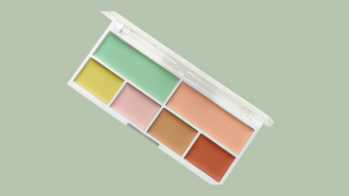 Woman applying green and peach color corrector on face