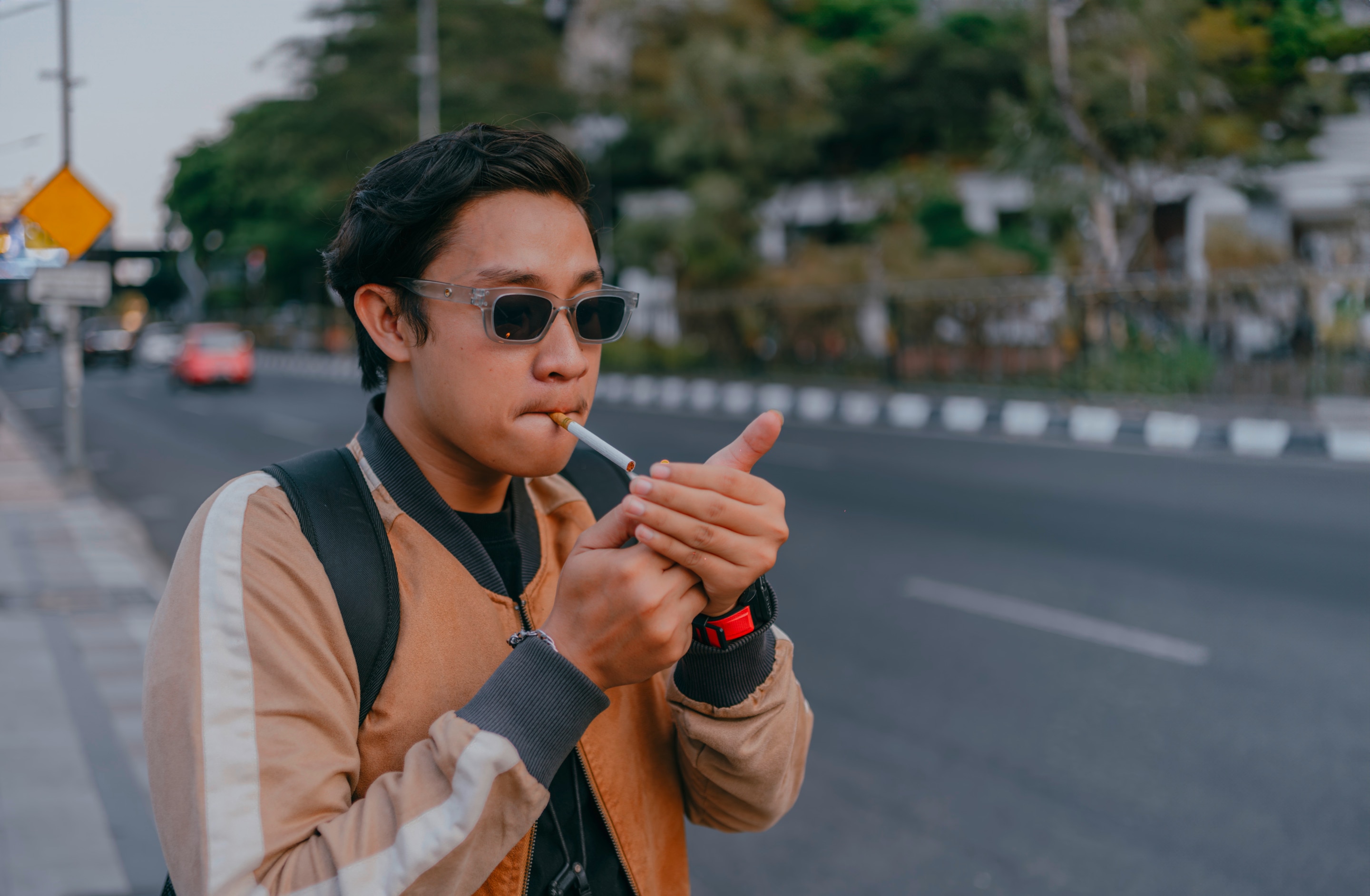 Man lighting up a cigarette.