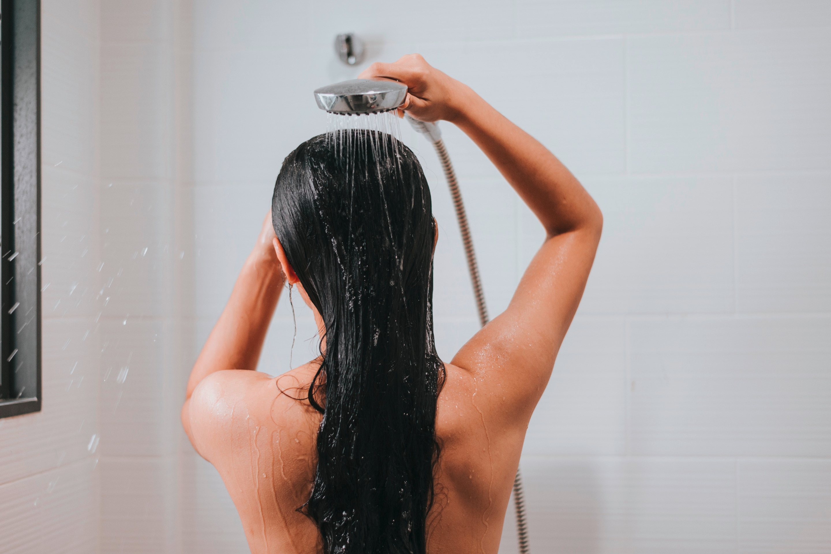 Woman rinsing her hair.