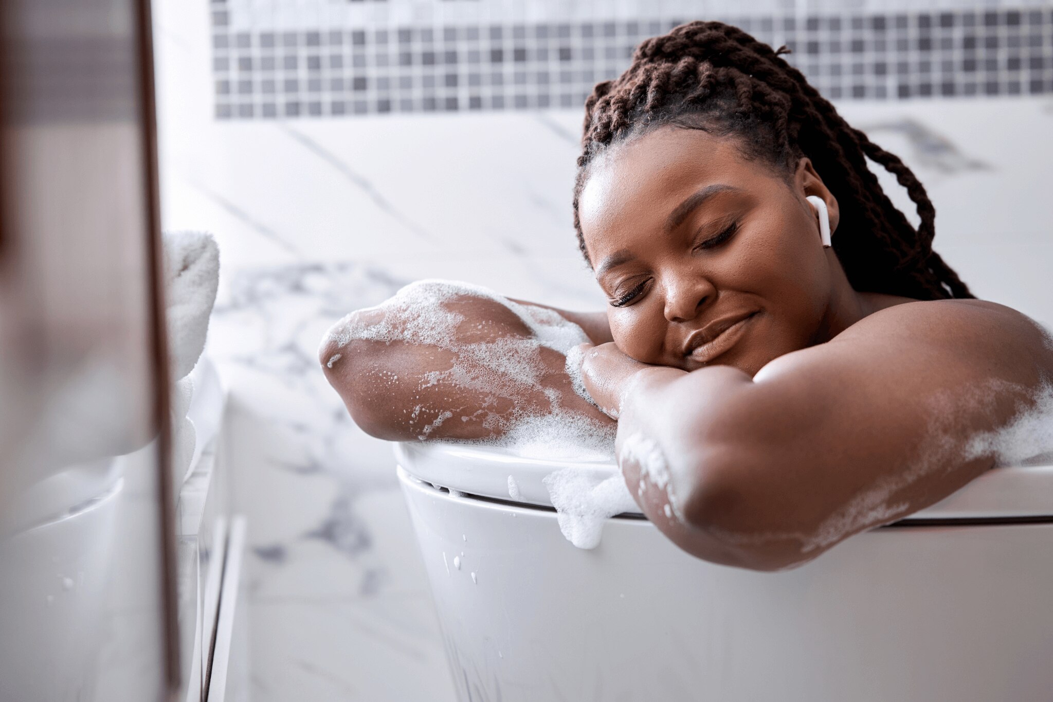 Woman relaxing in her bath tub after using body wash