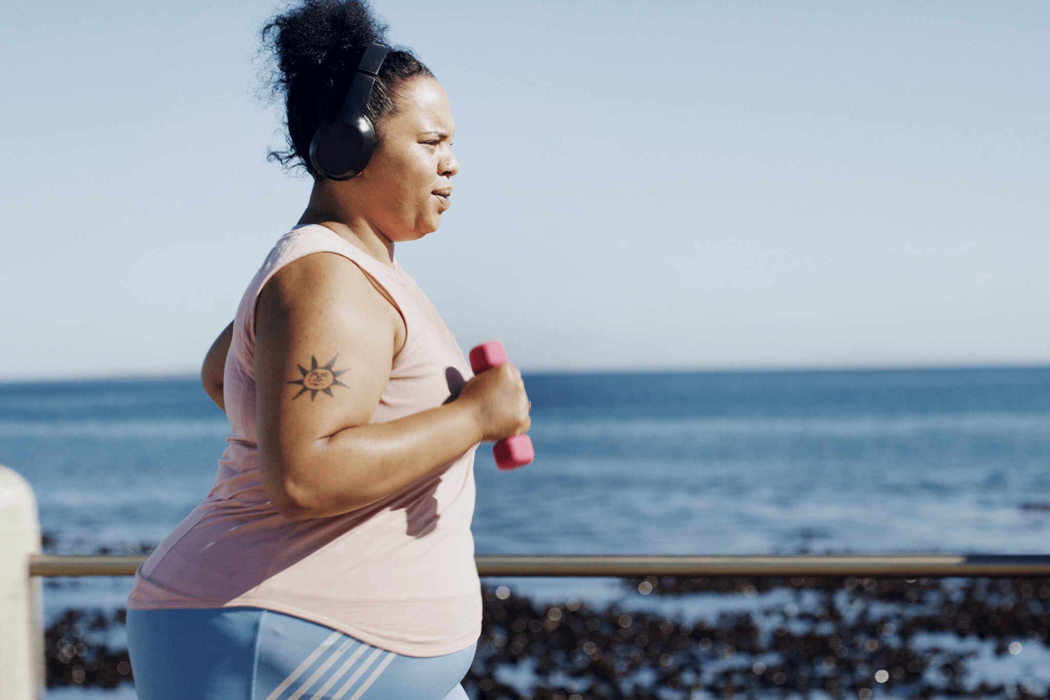 Plus size woman running by the beach with no sign of chafing