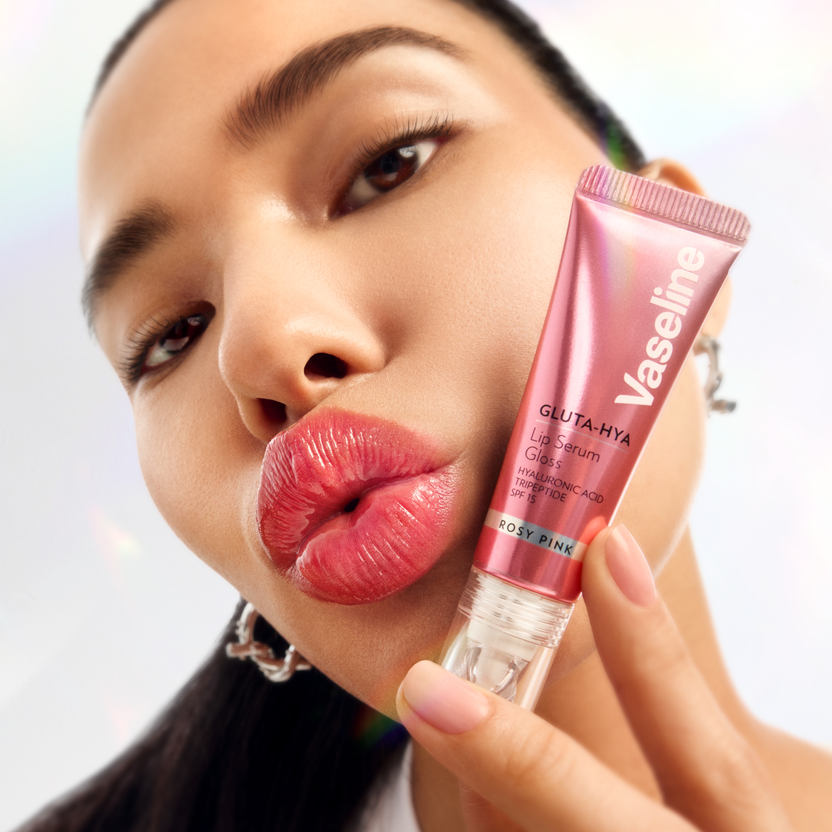 Woman holding the vaseline gluta hypa lip serum collection 