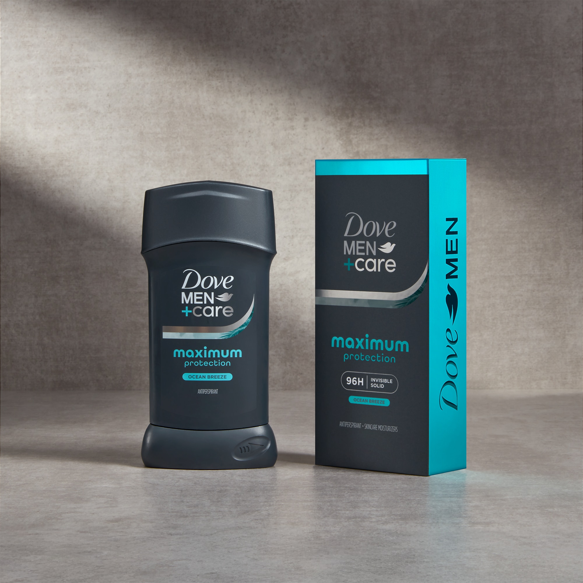 Pack of maximum protection ocean breeze invisible deodorant stick standing against a grey background with product box next to it 