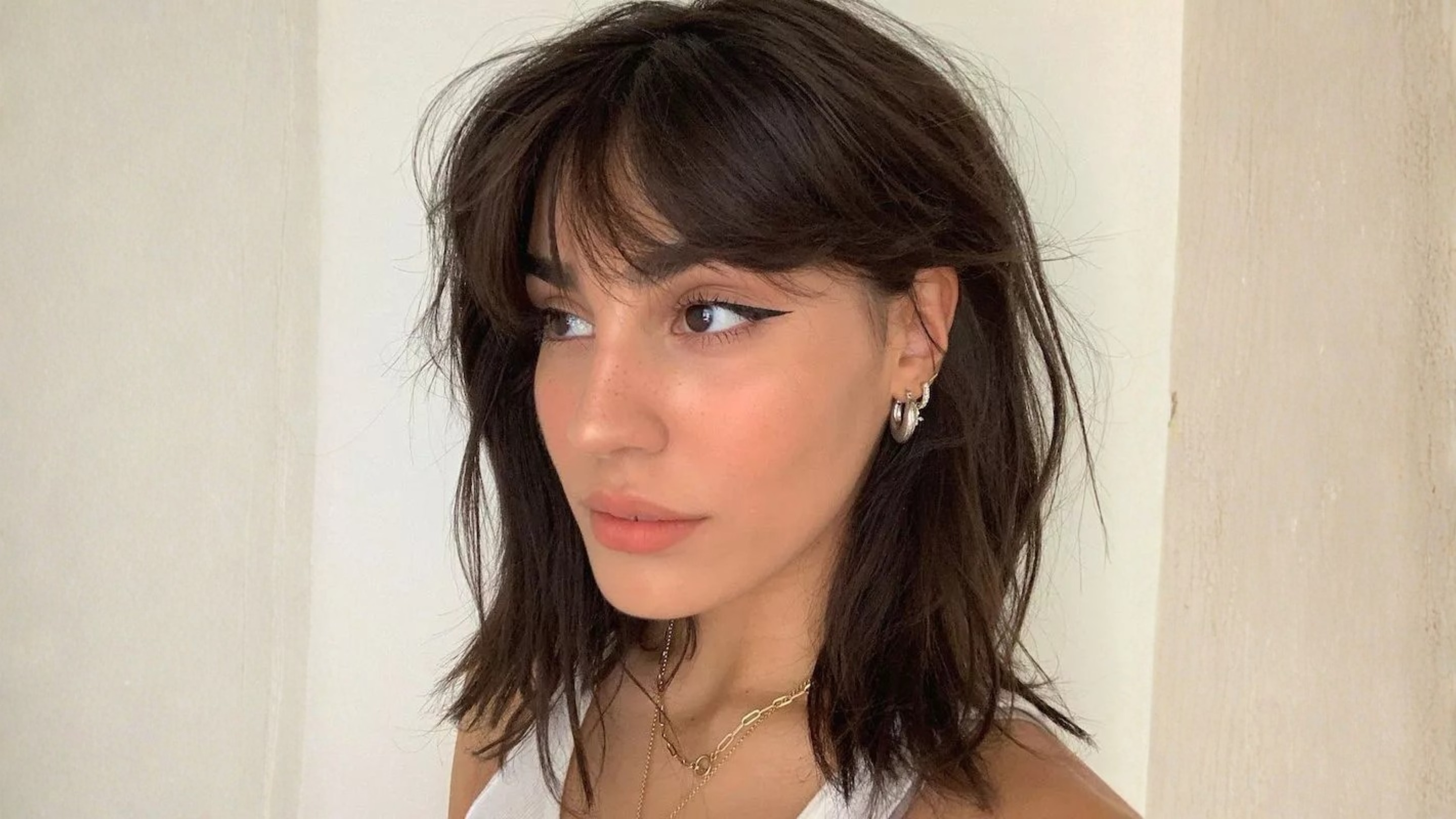 2. Curtain Bangs with Layers: