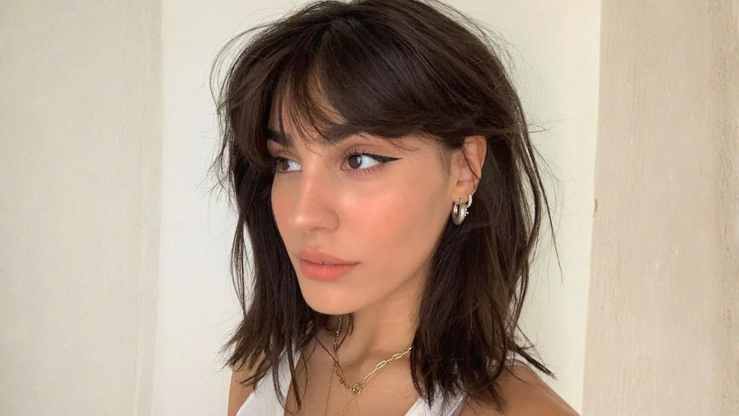 2. Curtain Bangs with Layers: