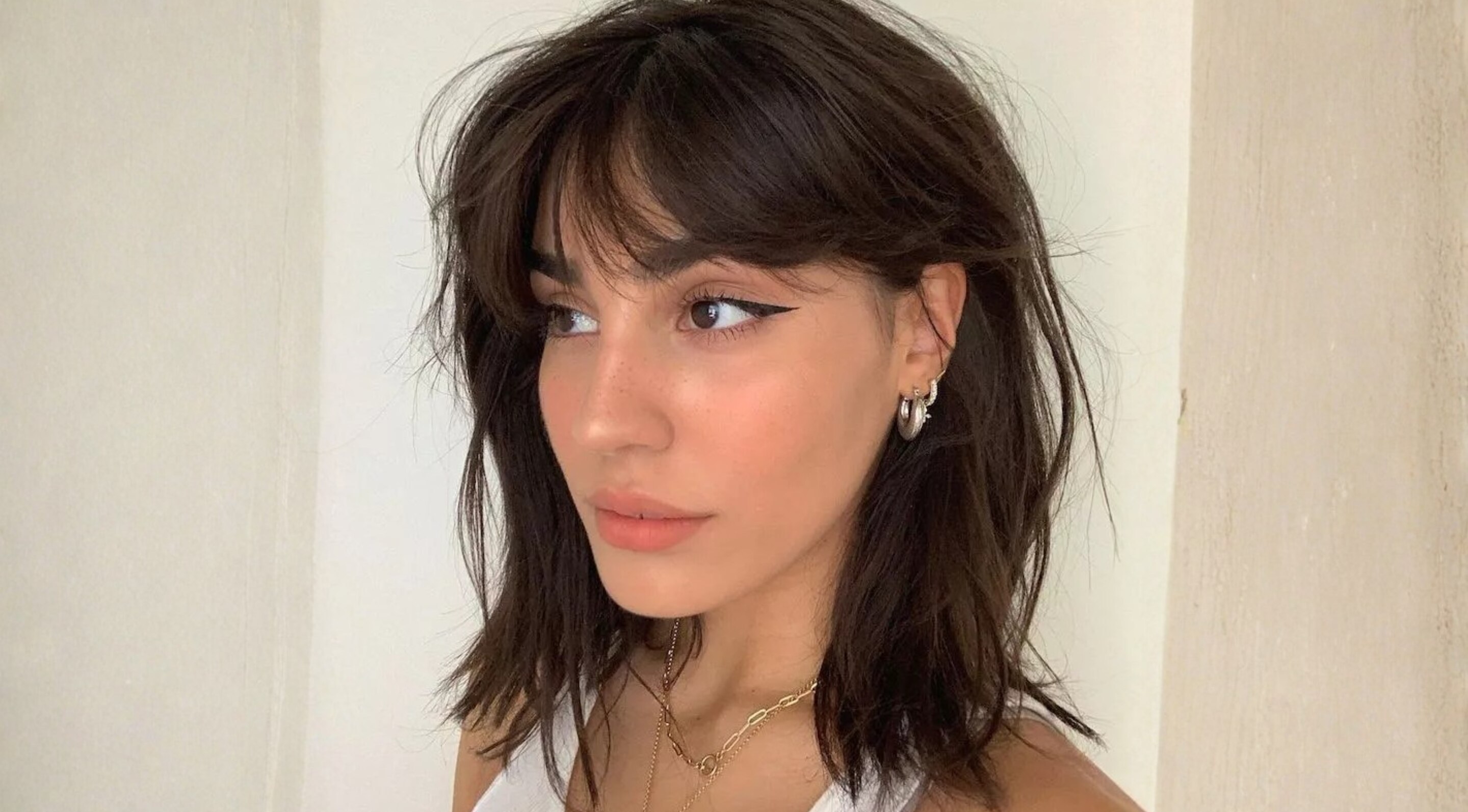 2. Curtain Bangs with Layers: