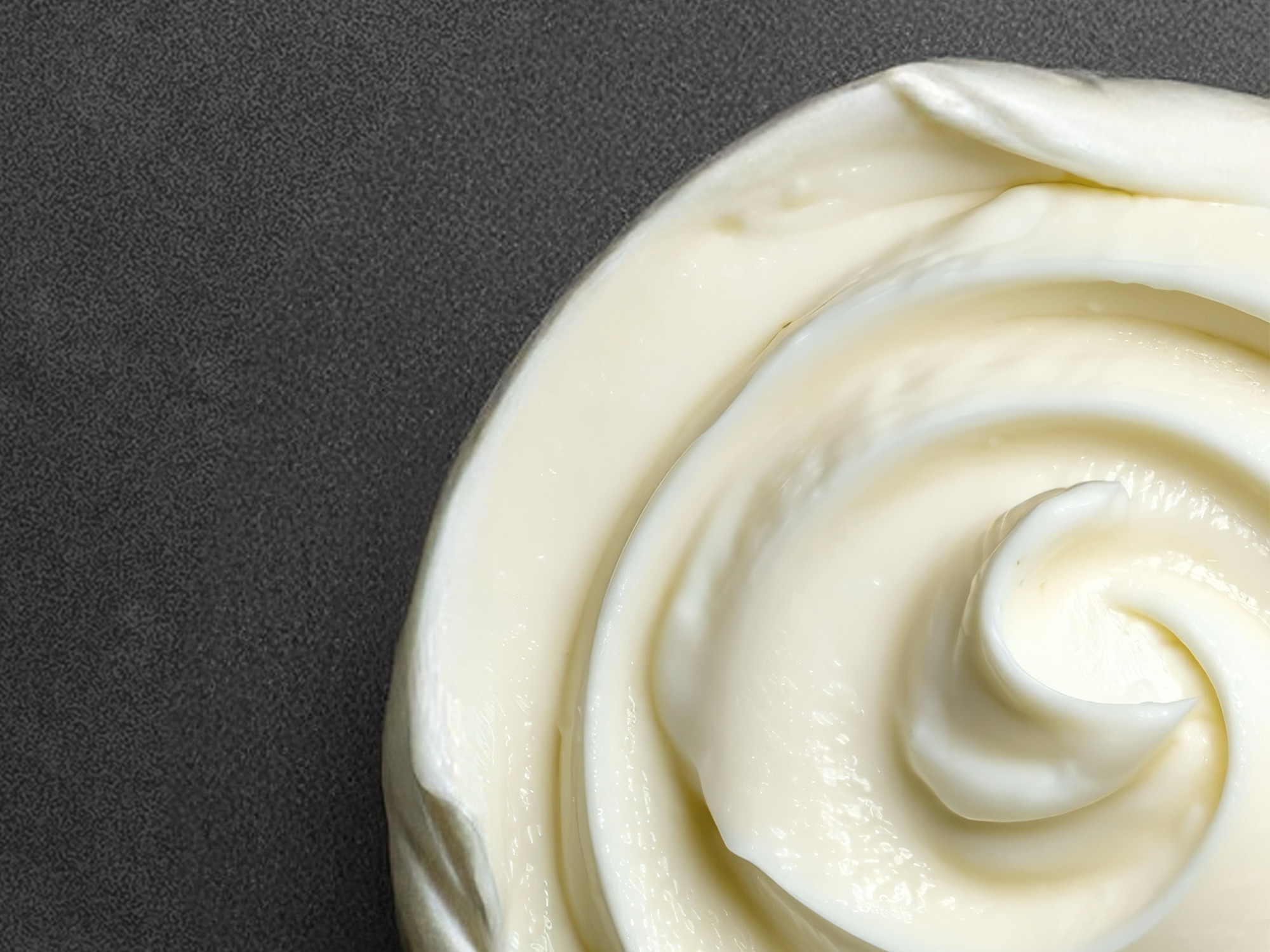 Whipped mosturizing cream against a grey background 