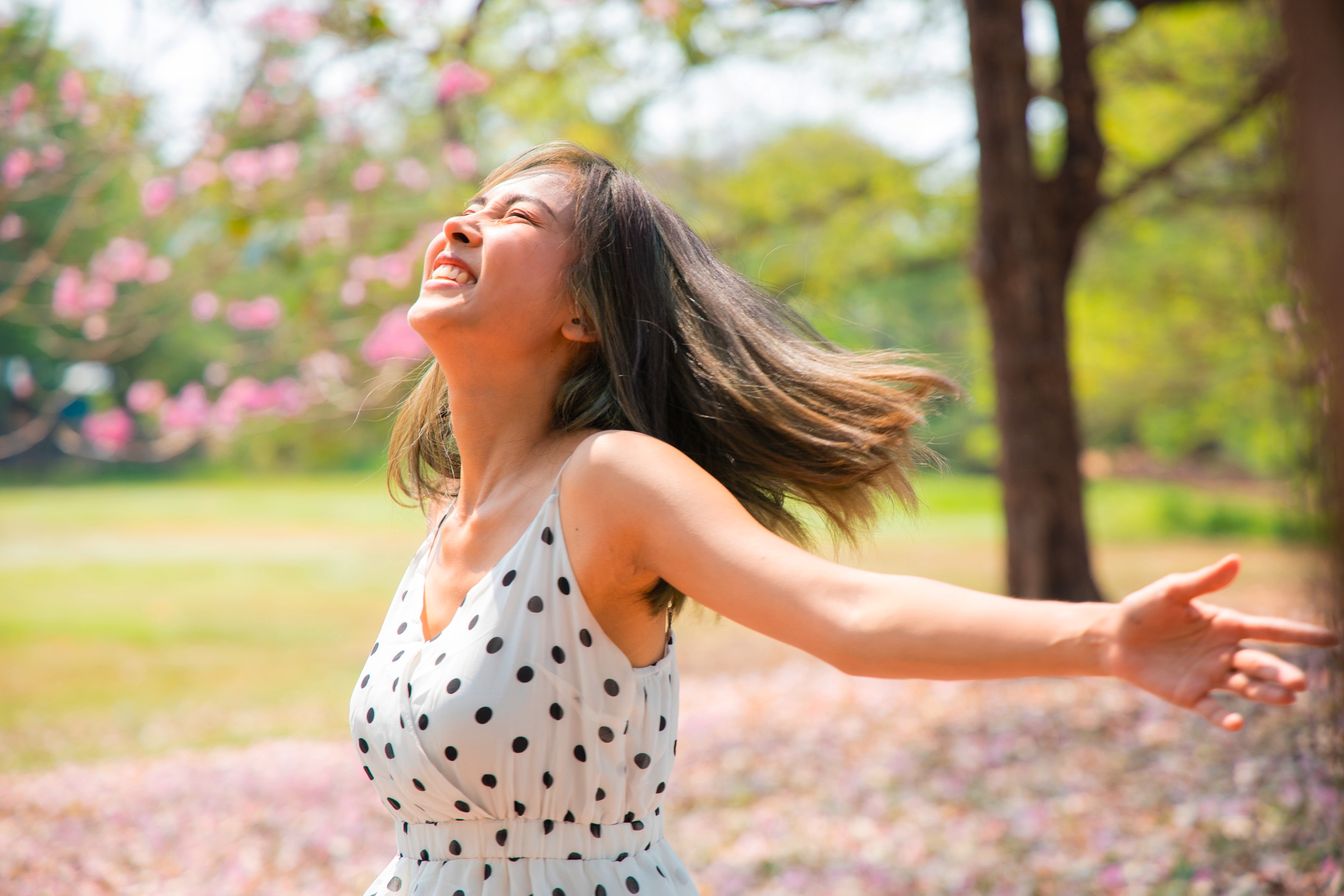 Woman with shoulder-length hair enjoying her time outdoors at the park.