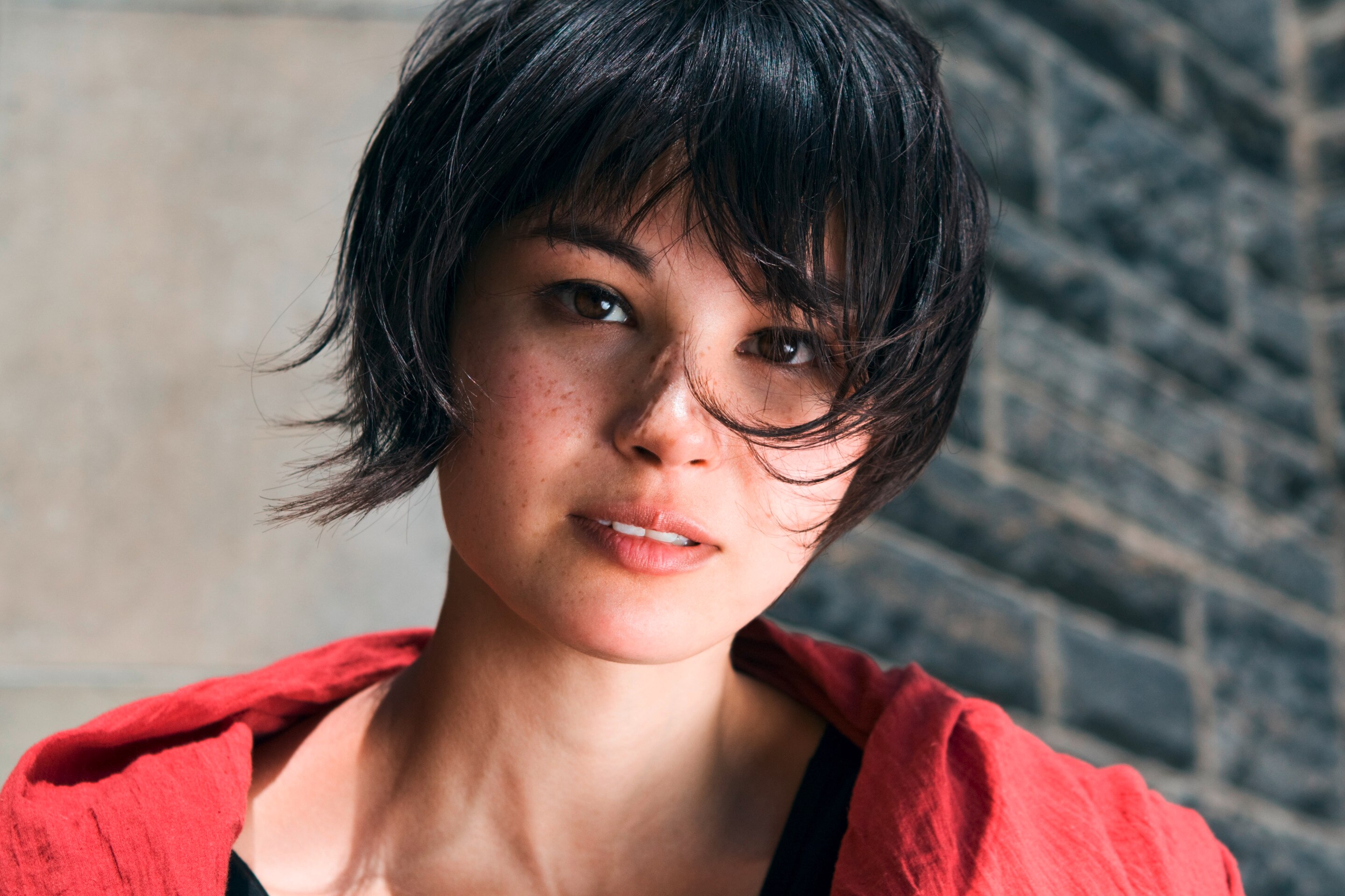 An Asian woman with a bixie cut.