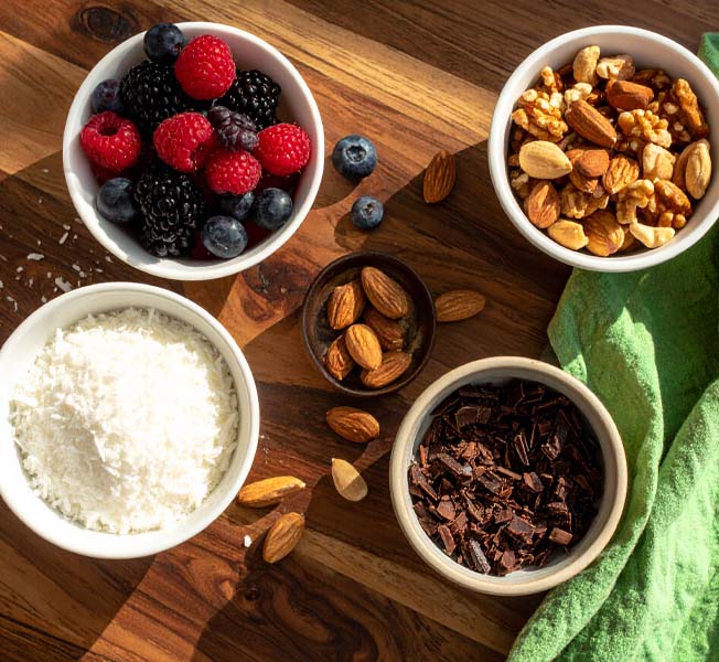 Set of bowls with healthy ice cream toppings