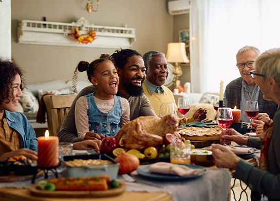 Happy group of family and friends enjoying a Thanksgiving meal
