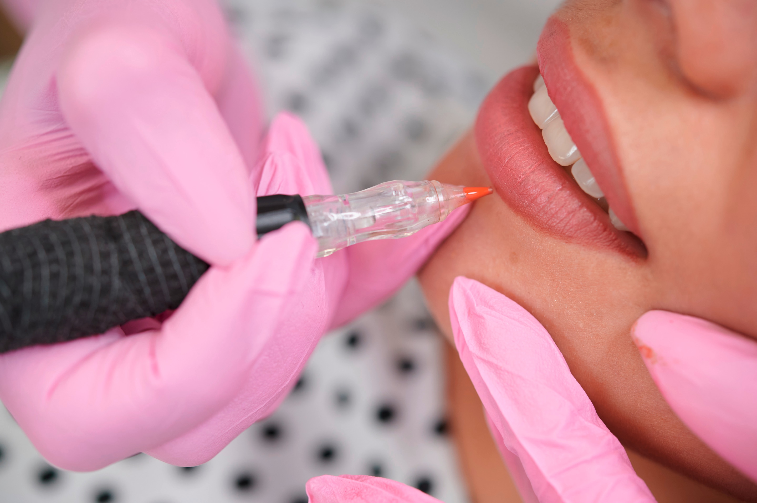 Closeup of a lip tattoo procedure.