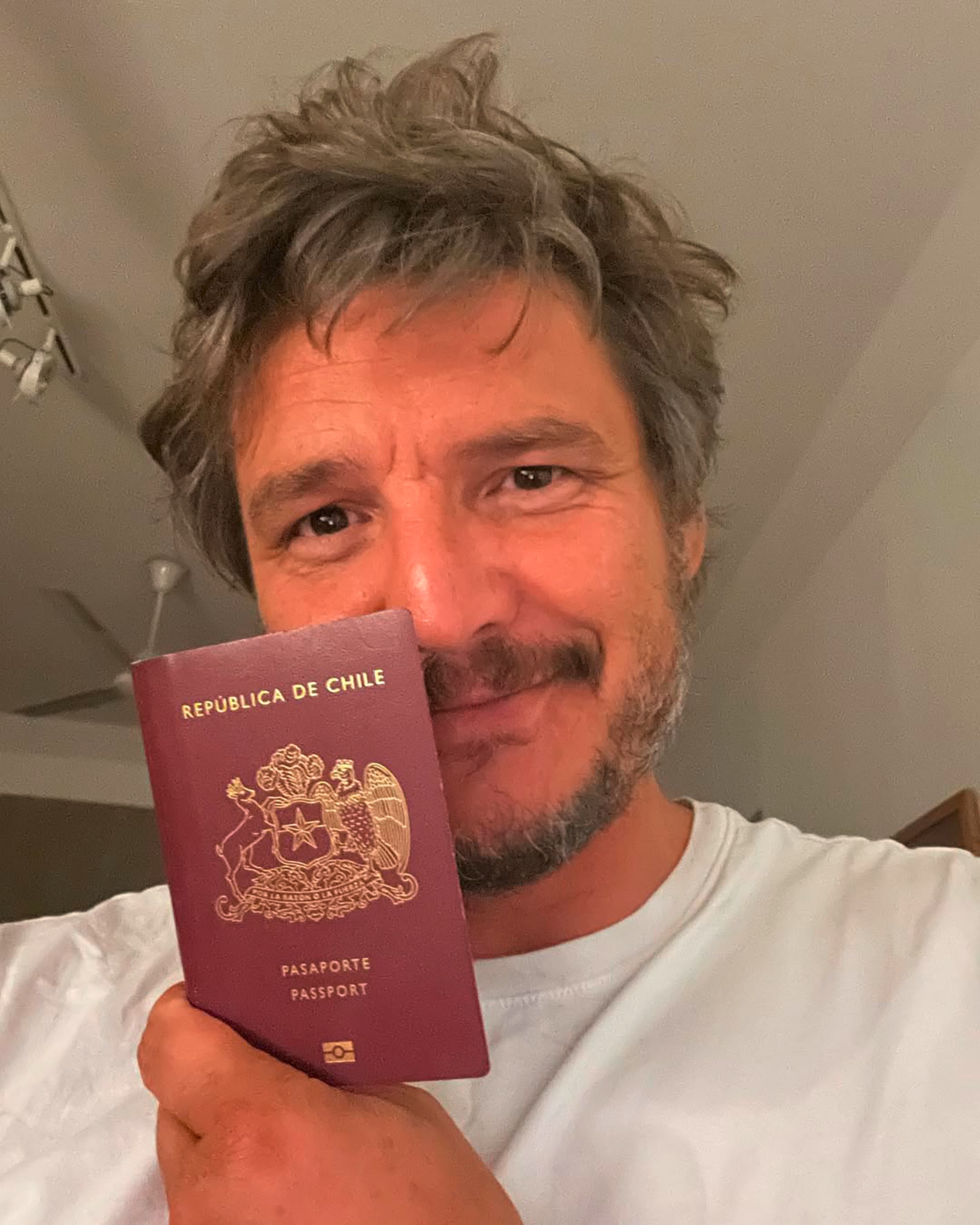 Actor Pedro Pascal holding up his passport.
