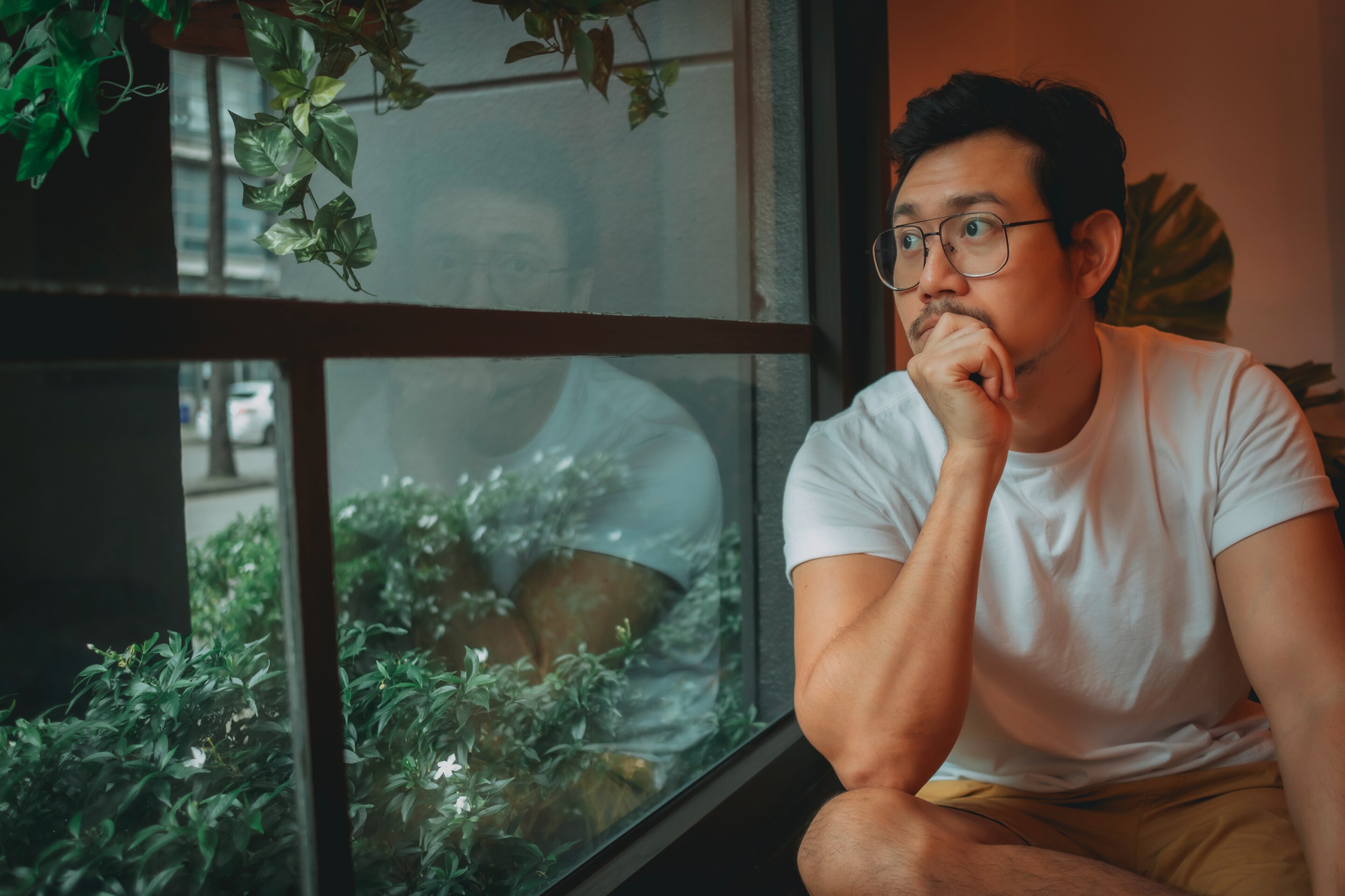 Single man looking out a window.