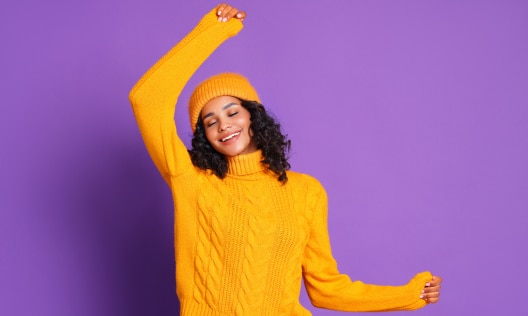 Happy African American woman in winter clothing with no sign of dry skin