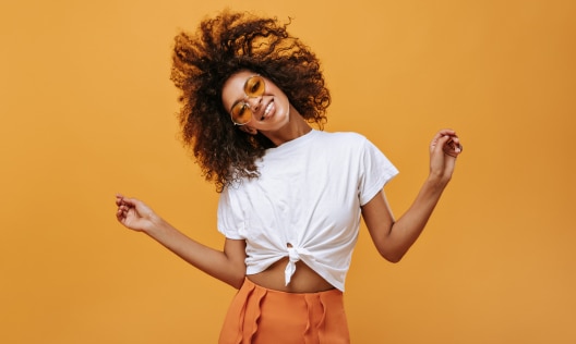 Happy young African American woman with beautiful, hydrated skin after using hyaluronic acid
