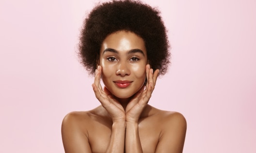 Young African American woman happy after using products with ceramides