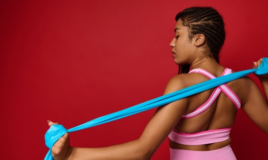 African American woman working out with resistance bands with zero sweat that smells like ammonia