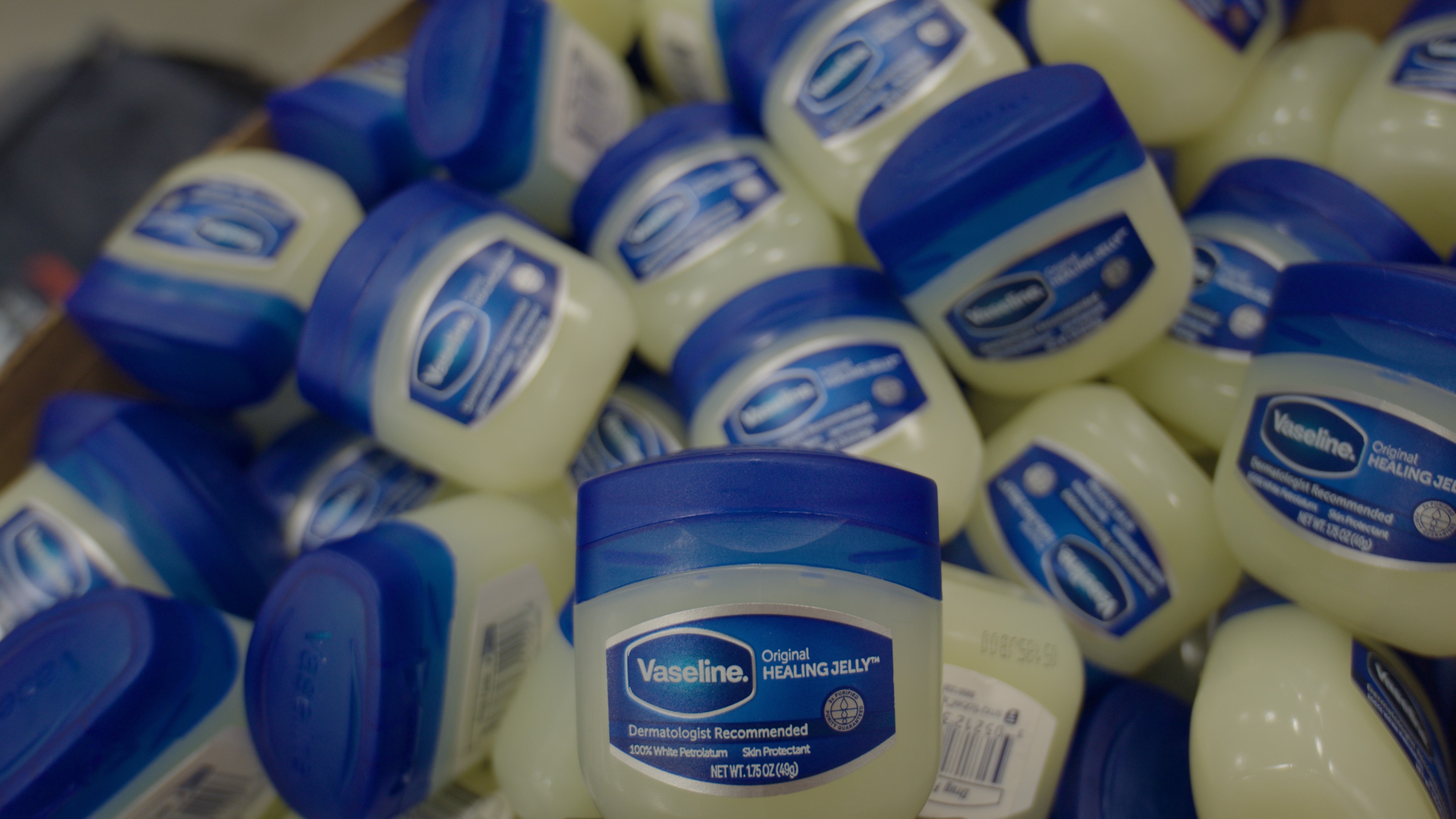 A pile of Vaseline Healing Jelly jars
