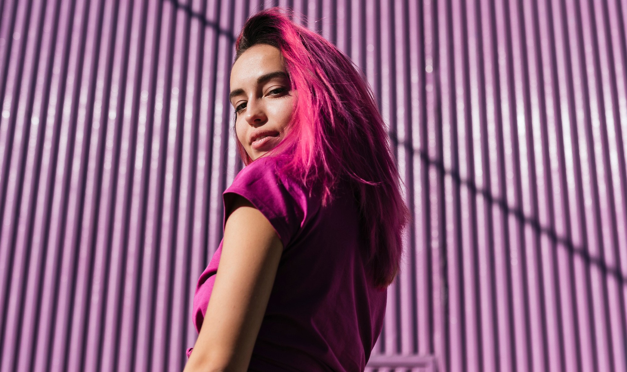 Woman with pink hair smiling