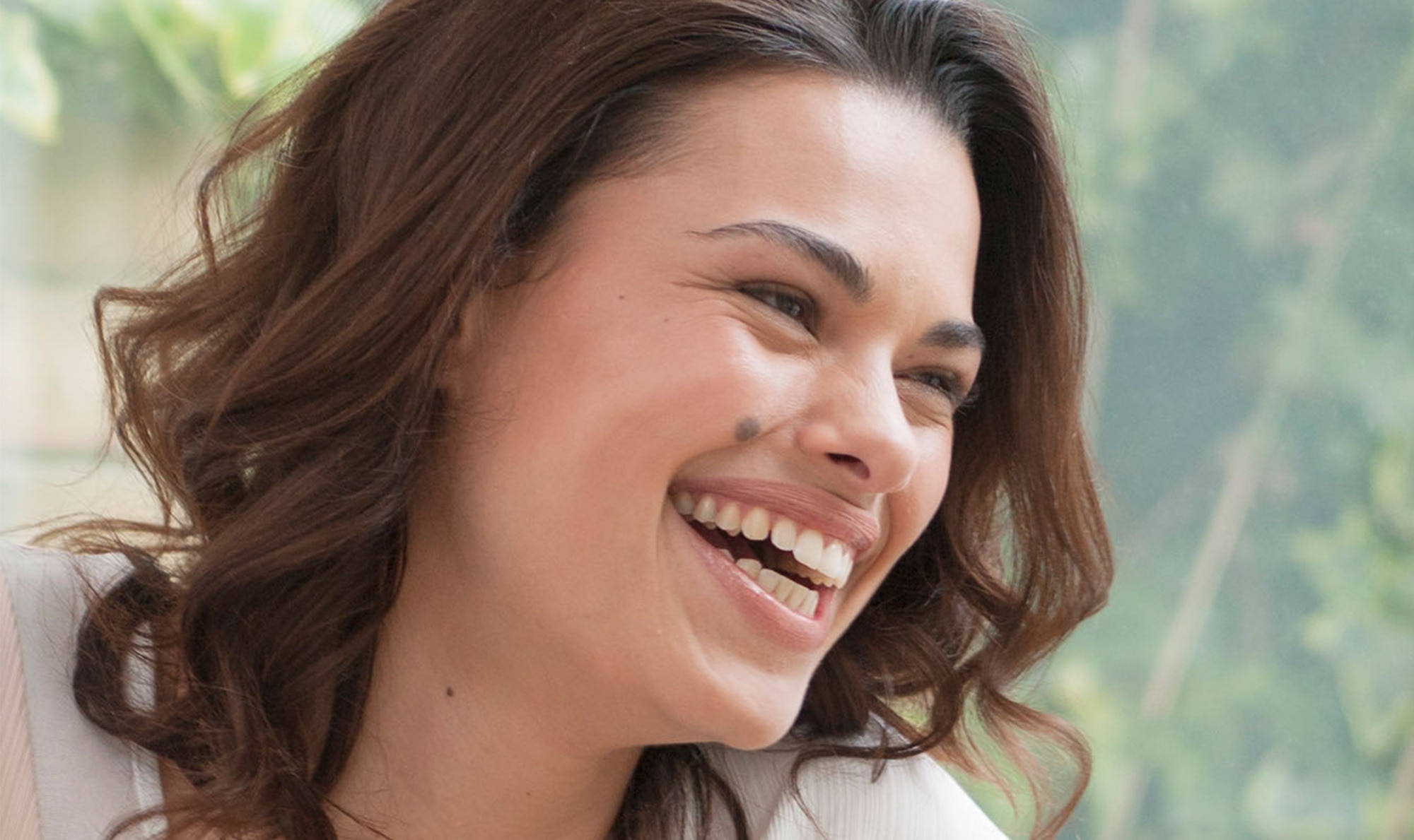 A smiling woman with long brown hair