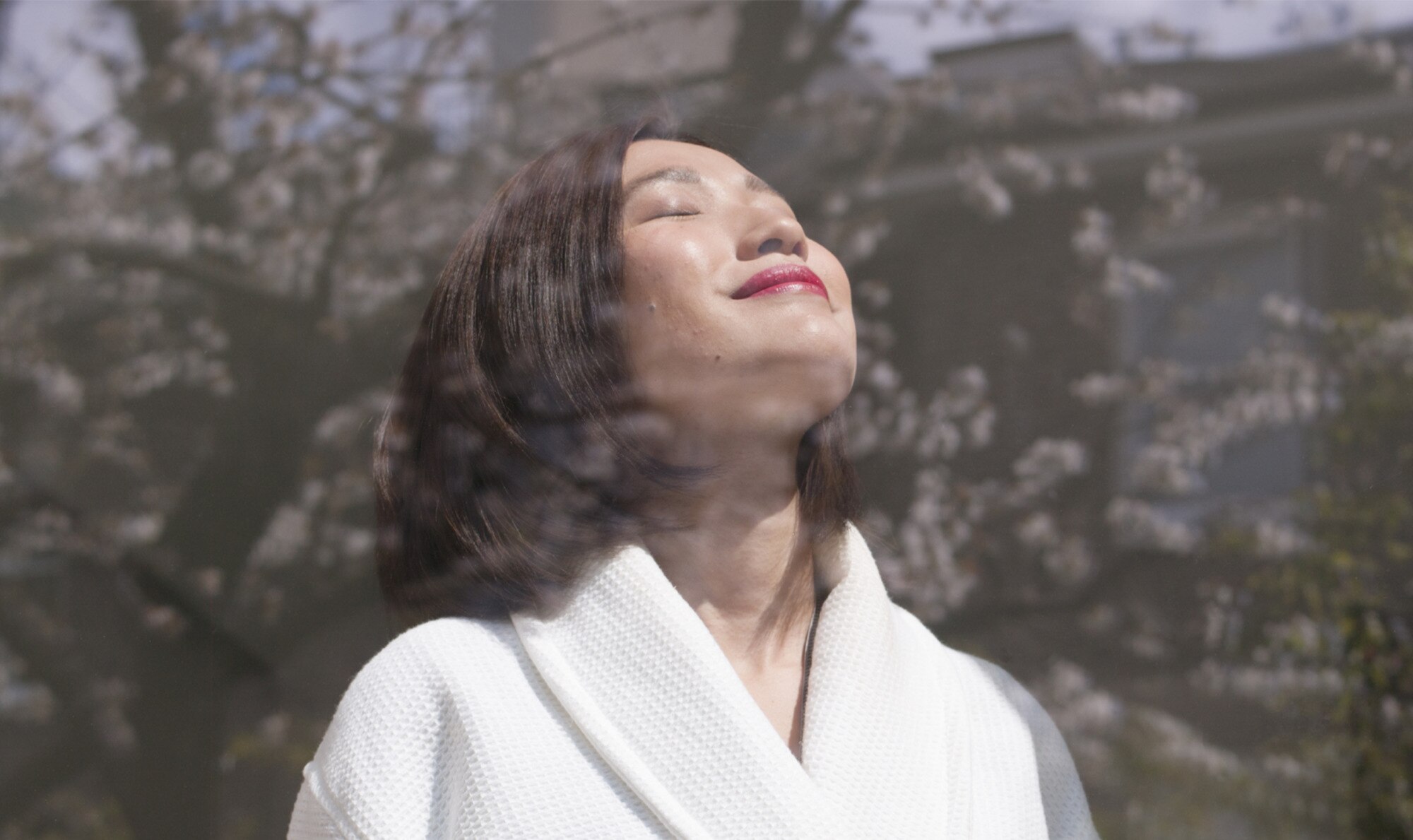 A woman smiles and looks upwards