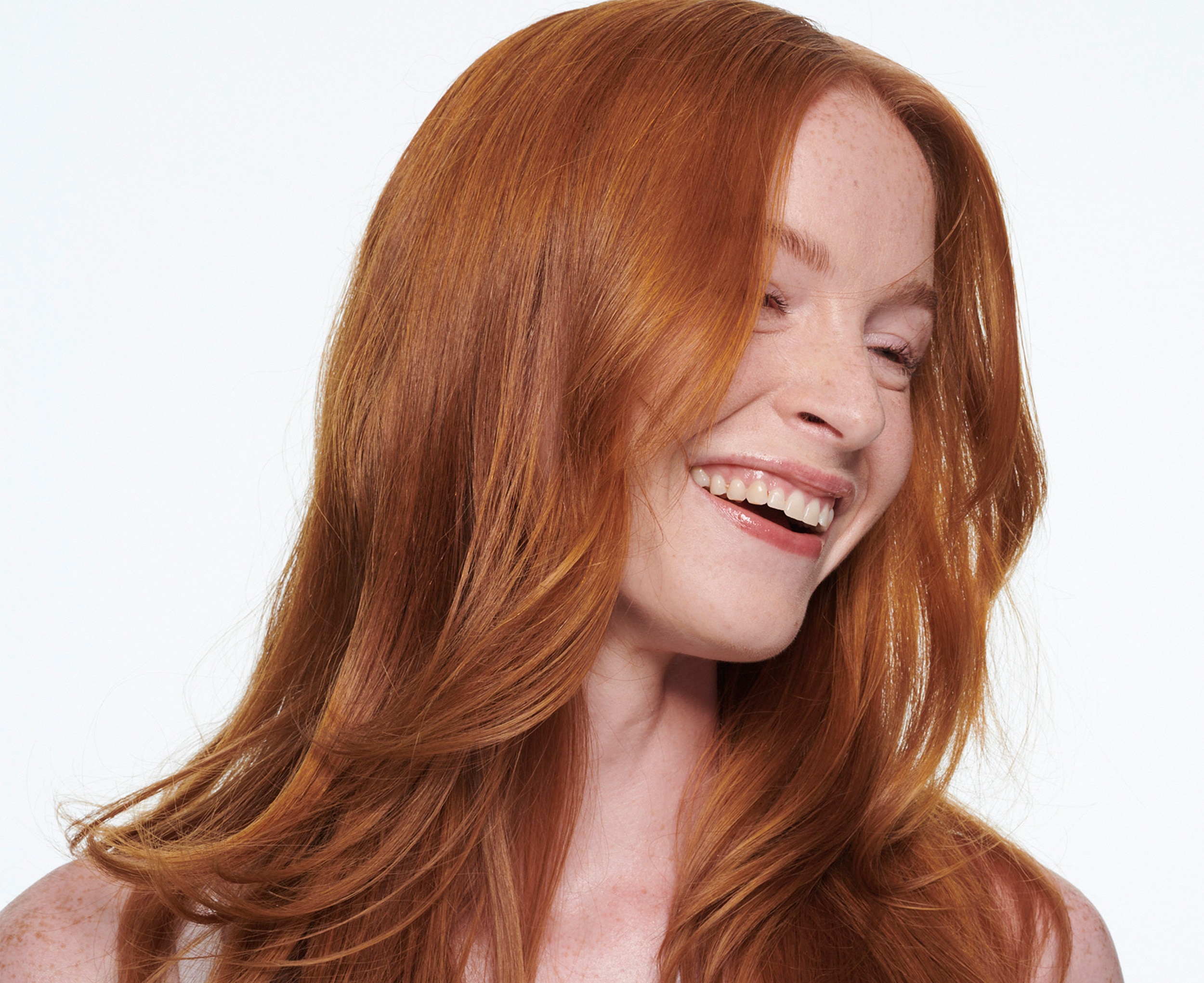 A woman smiling with wavy hair