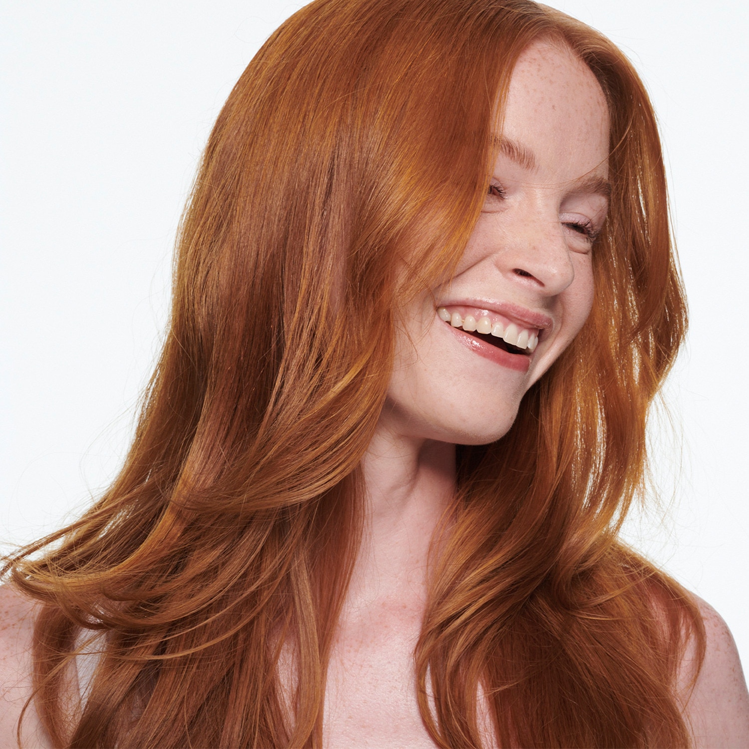 A woman with long red hair smiling