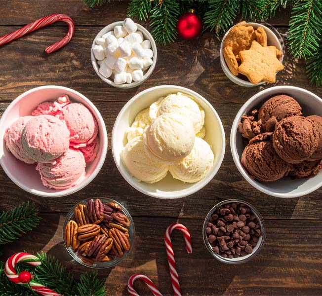 Holiday Dessert table with various ice cream flavors and ice cream toppings like marshmallows and nuts