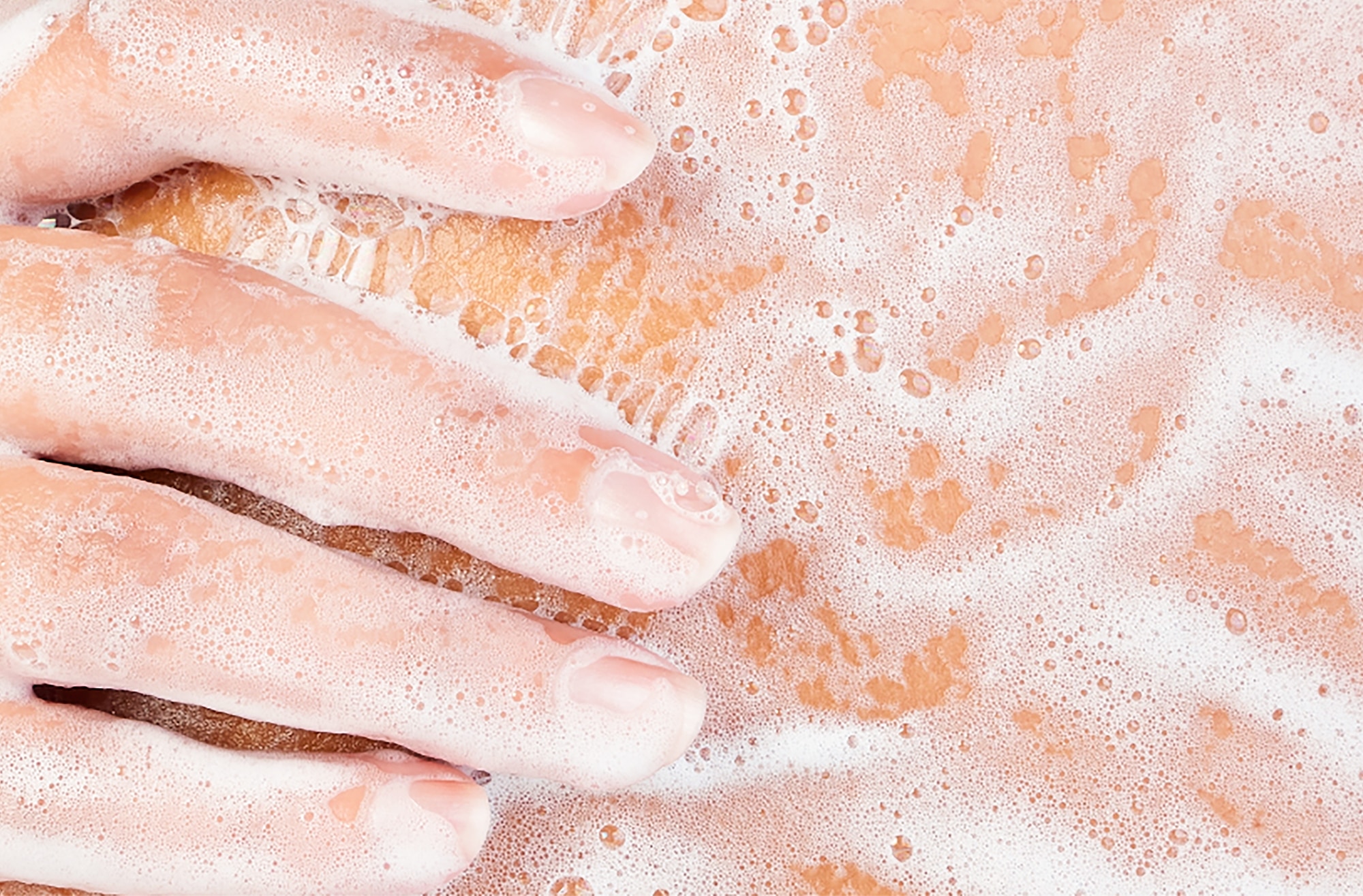 Hand lathering body wash on body