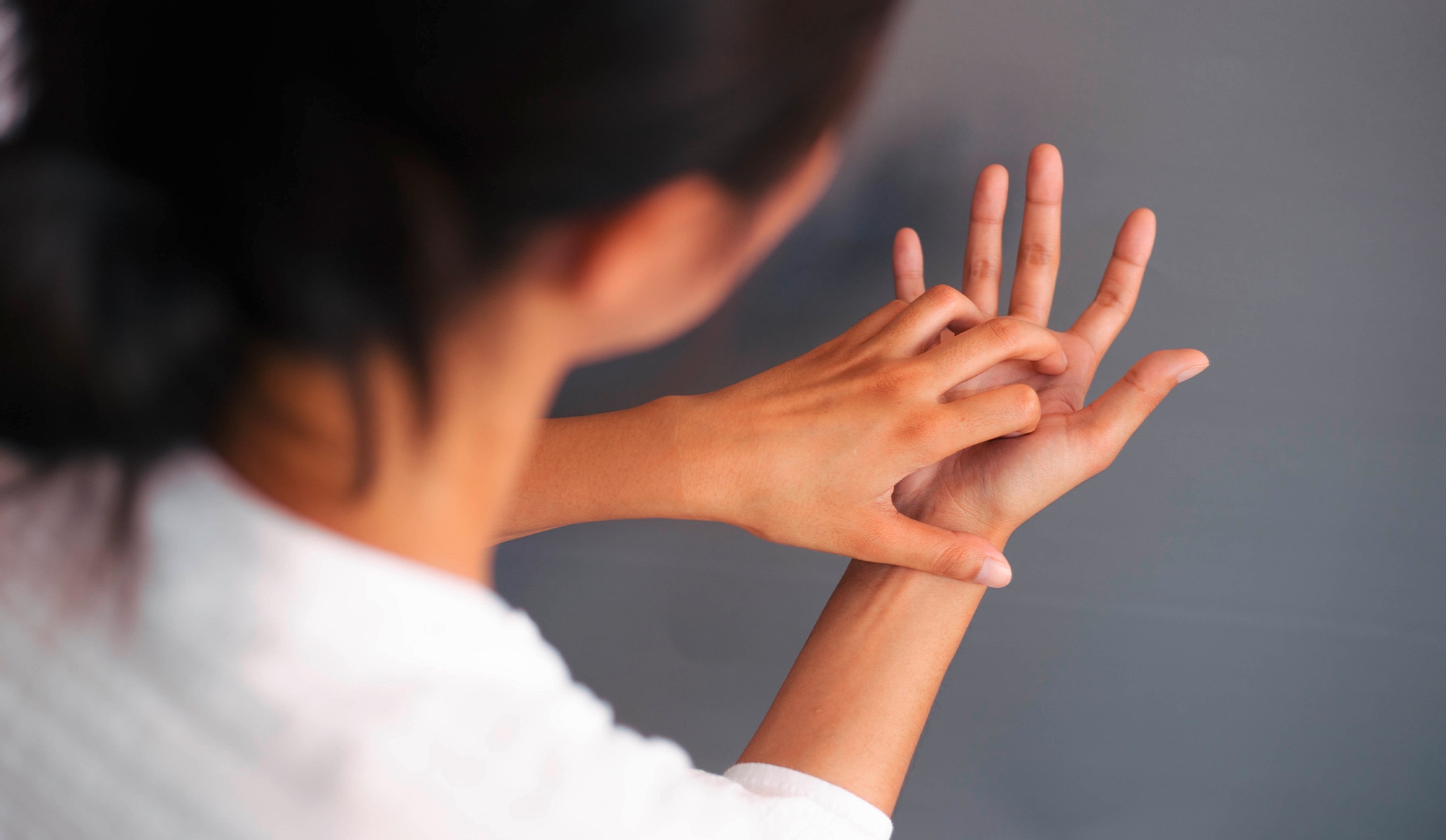 Woman rubbing moisturizer into her hands