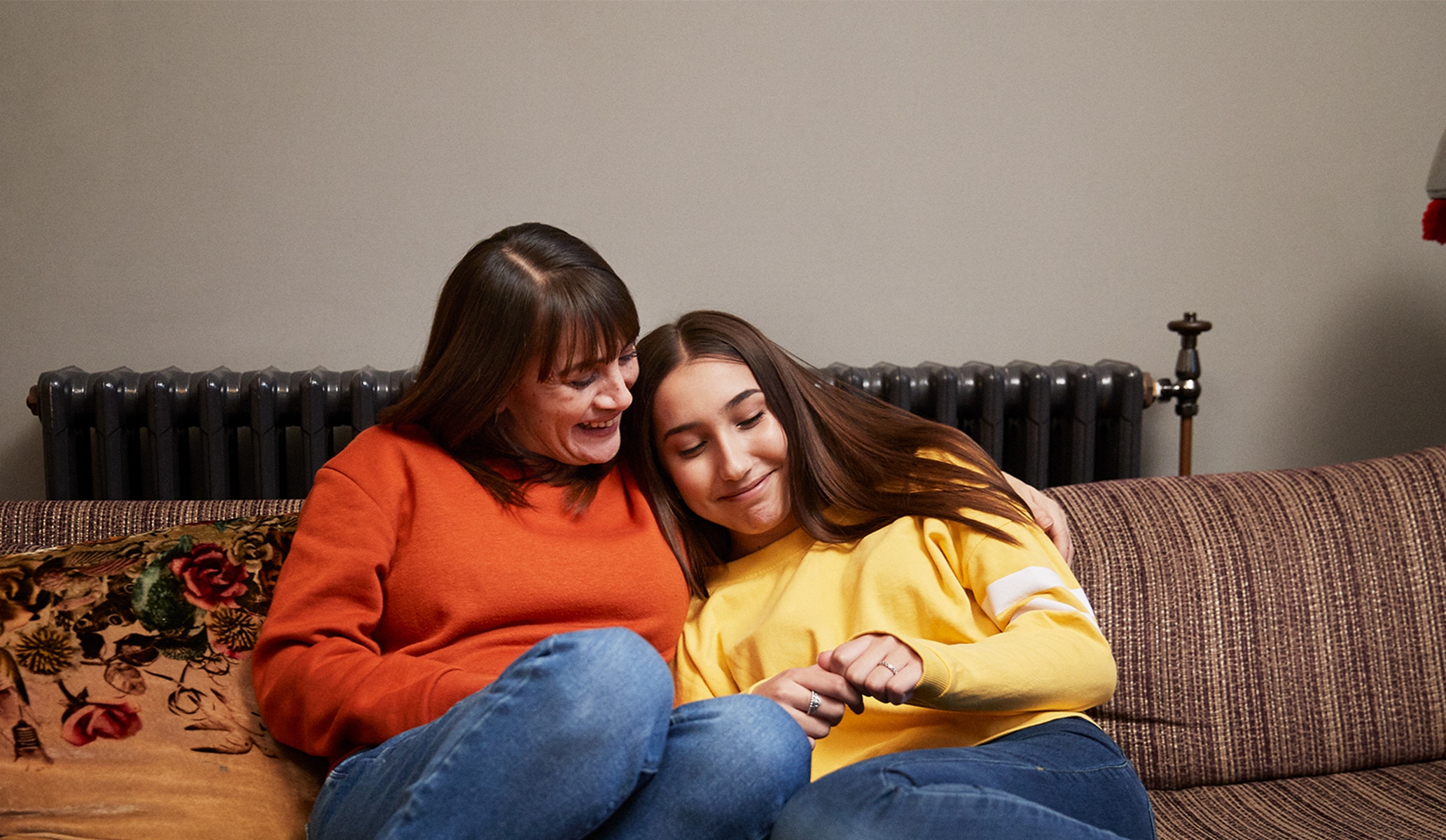 A coconut shell against a milky texture with petals surounding it