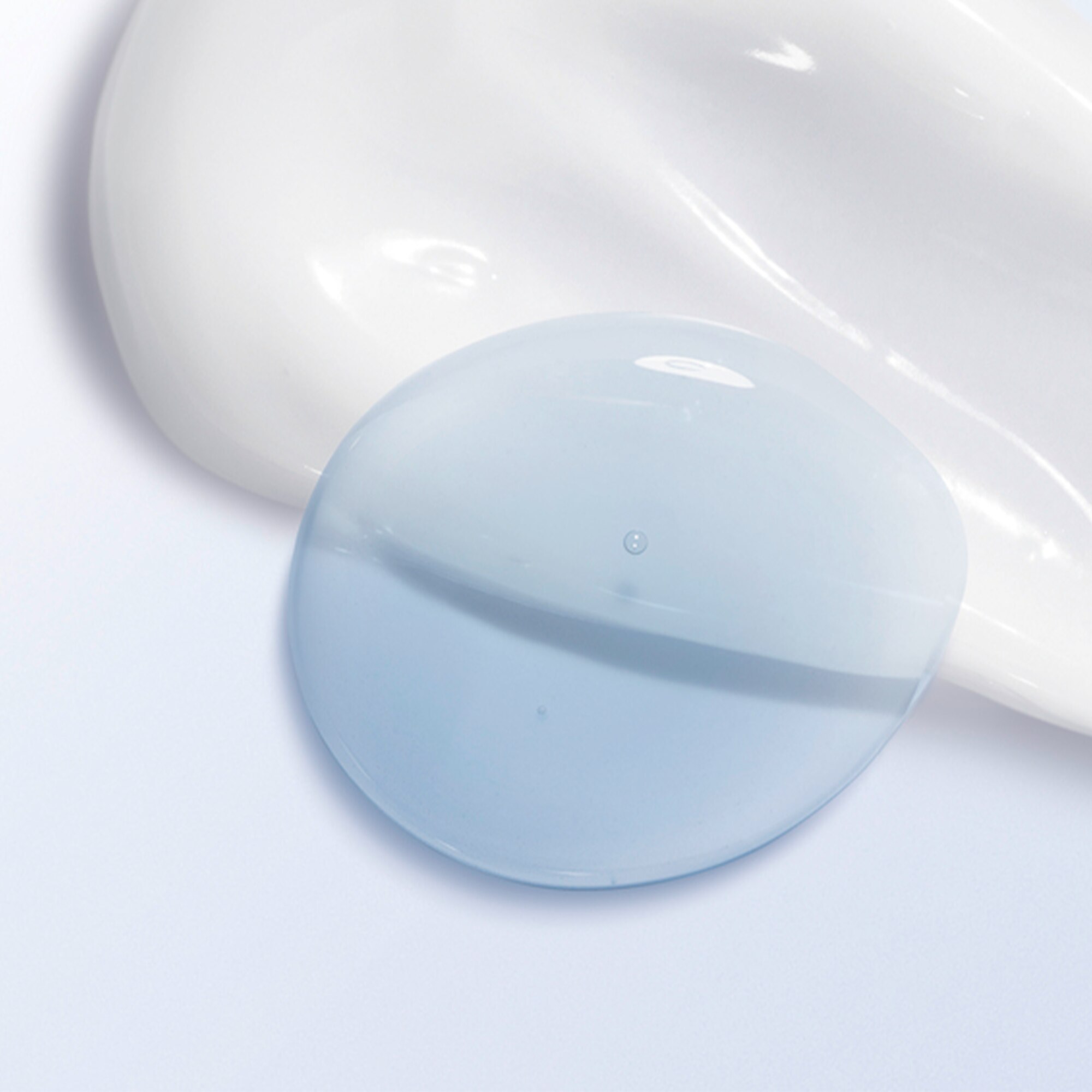 Image of white and blue serum product swatches