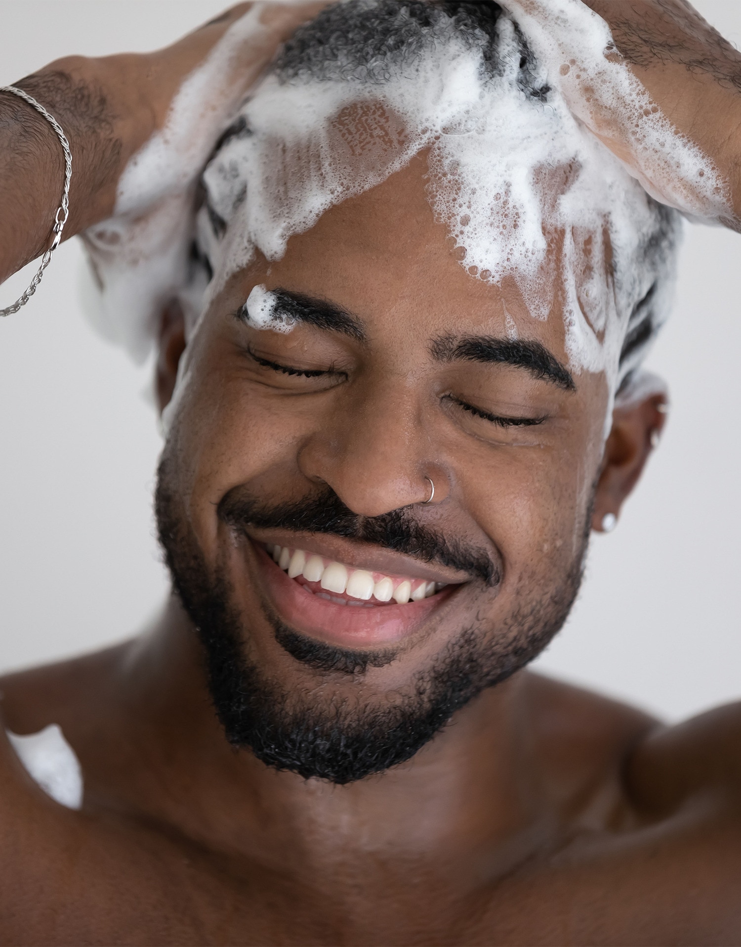 Man shampooing his hair in the shower