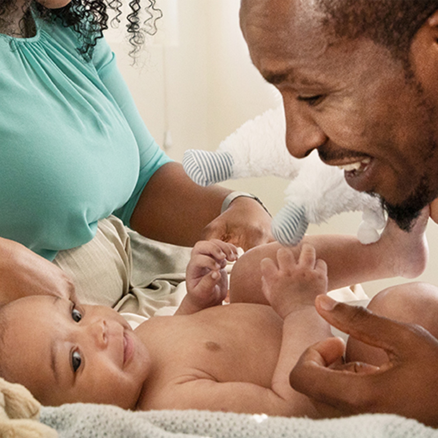 Father smiling down at his smiling baby