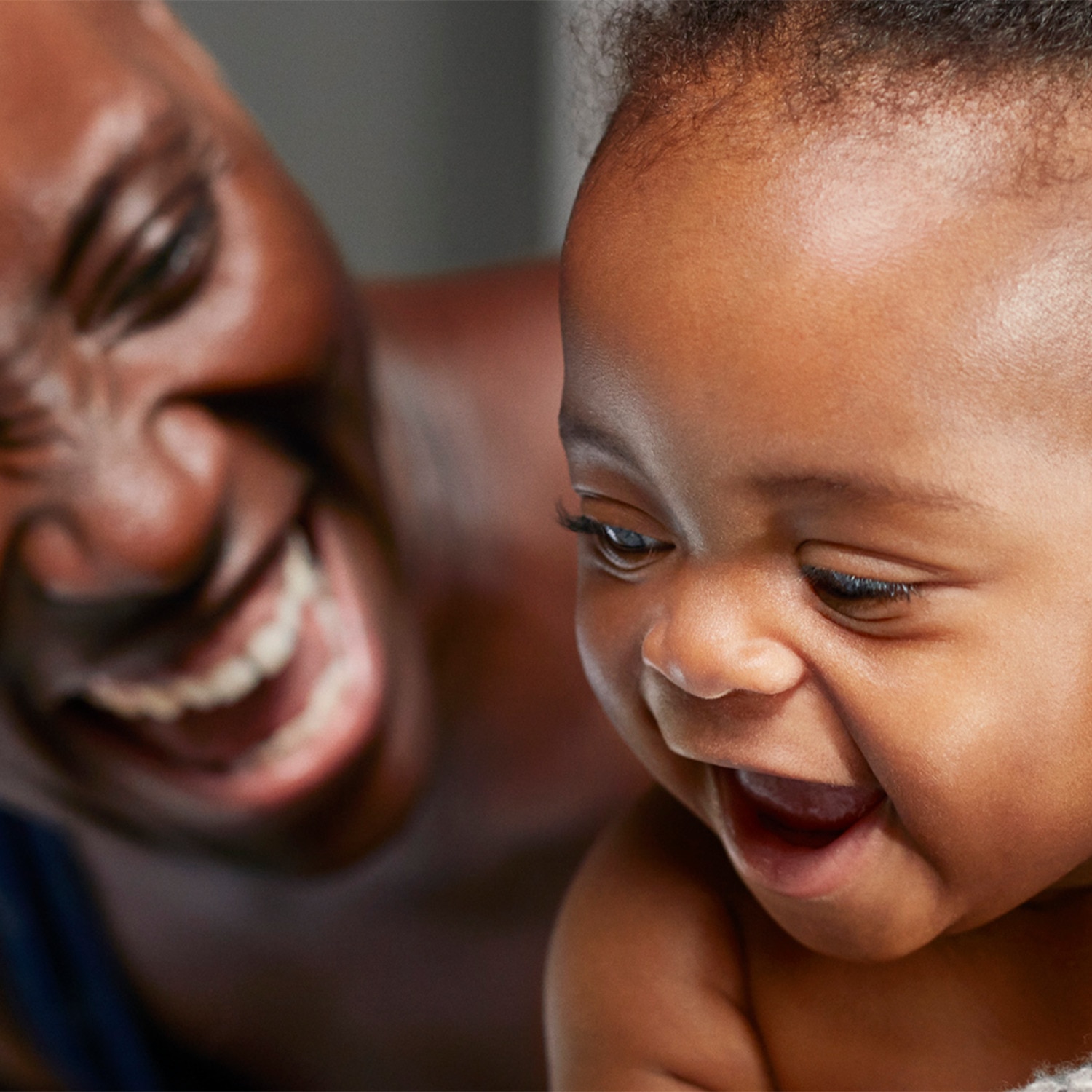 Image of a father and his baby laughing together