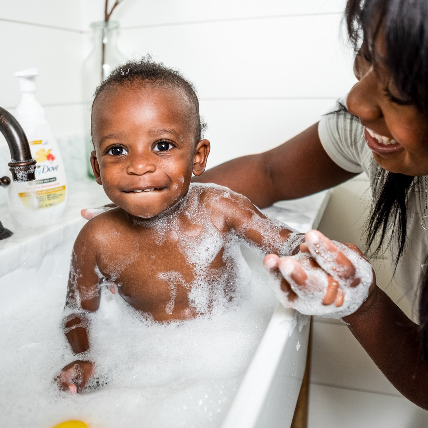 Image of a baby being bathed in a bubble bath